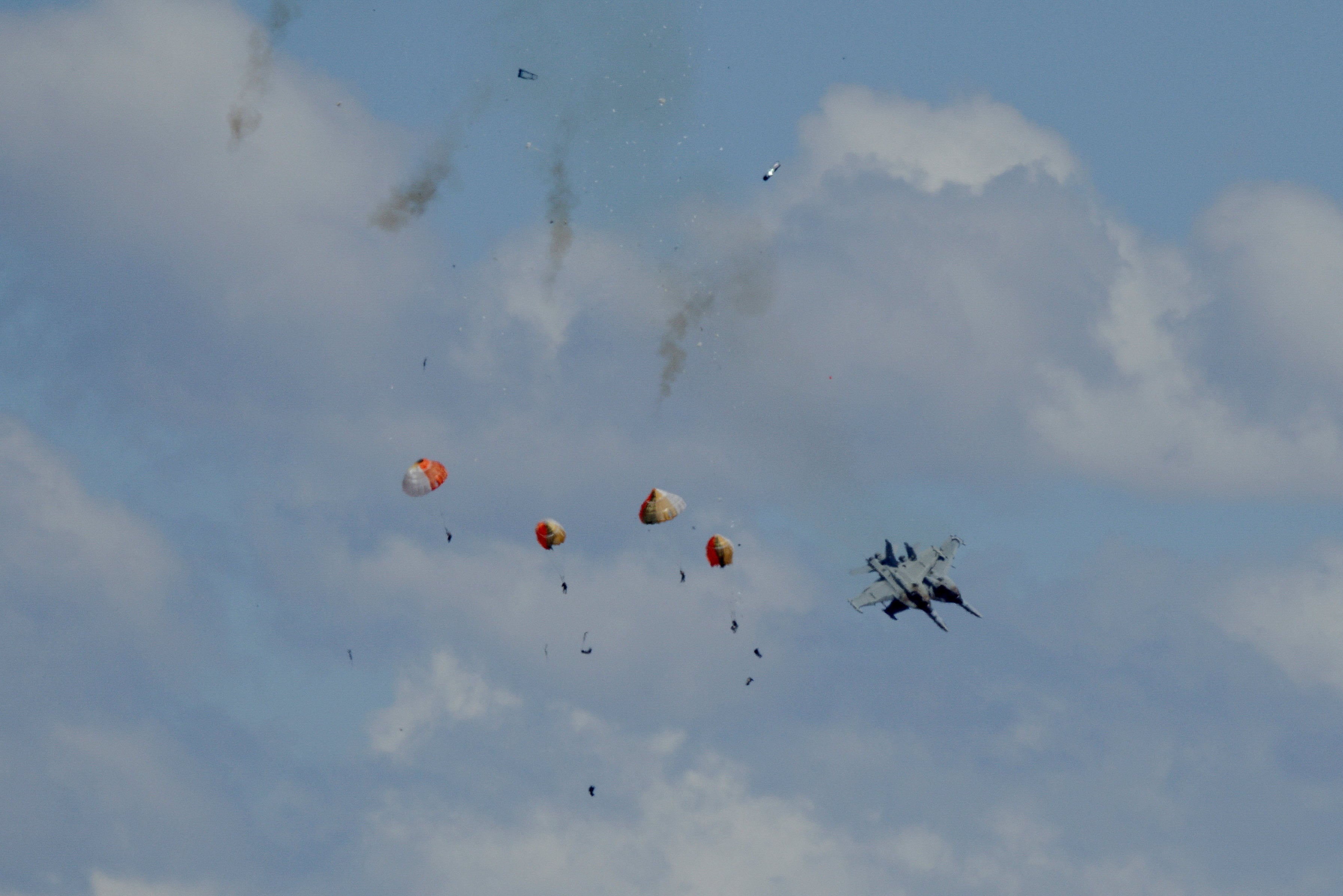 Four parachutes open in the sky as the aircraft plummet to the ground. Photo: Henk Zuurbier via Reuters