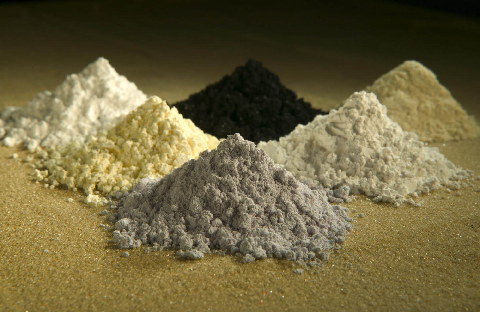 Clockwise from top centre are the rare earth oxides praseodymium, cerium, lanthanum, neodymium, samarium and gadolinium. Photo: USDA-ARS