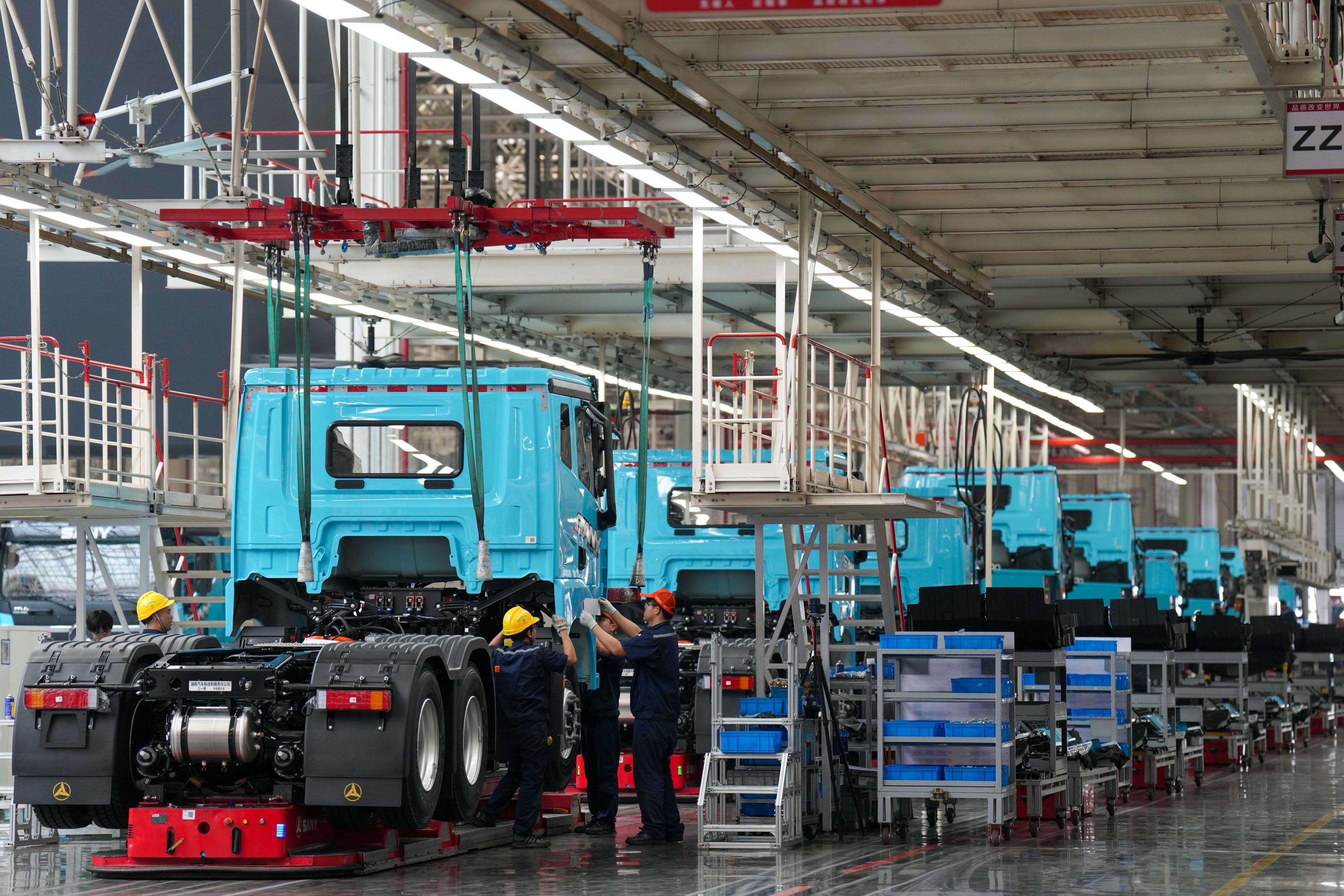 Workers at a Sany new energy heavy truck factory in Changsha, Hunan province, on May 12. A new truck rolls off the production line every six minutes. Photo: Xinhua