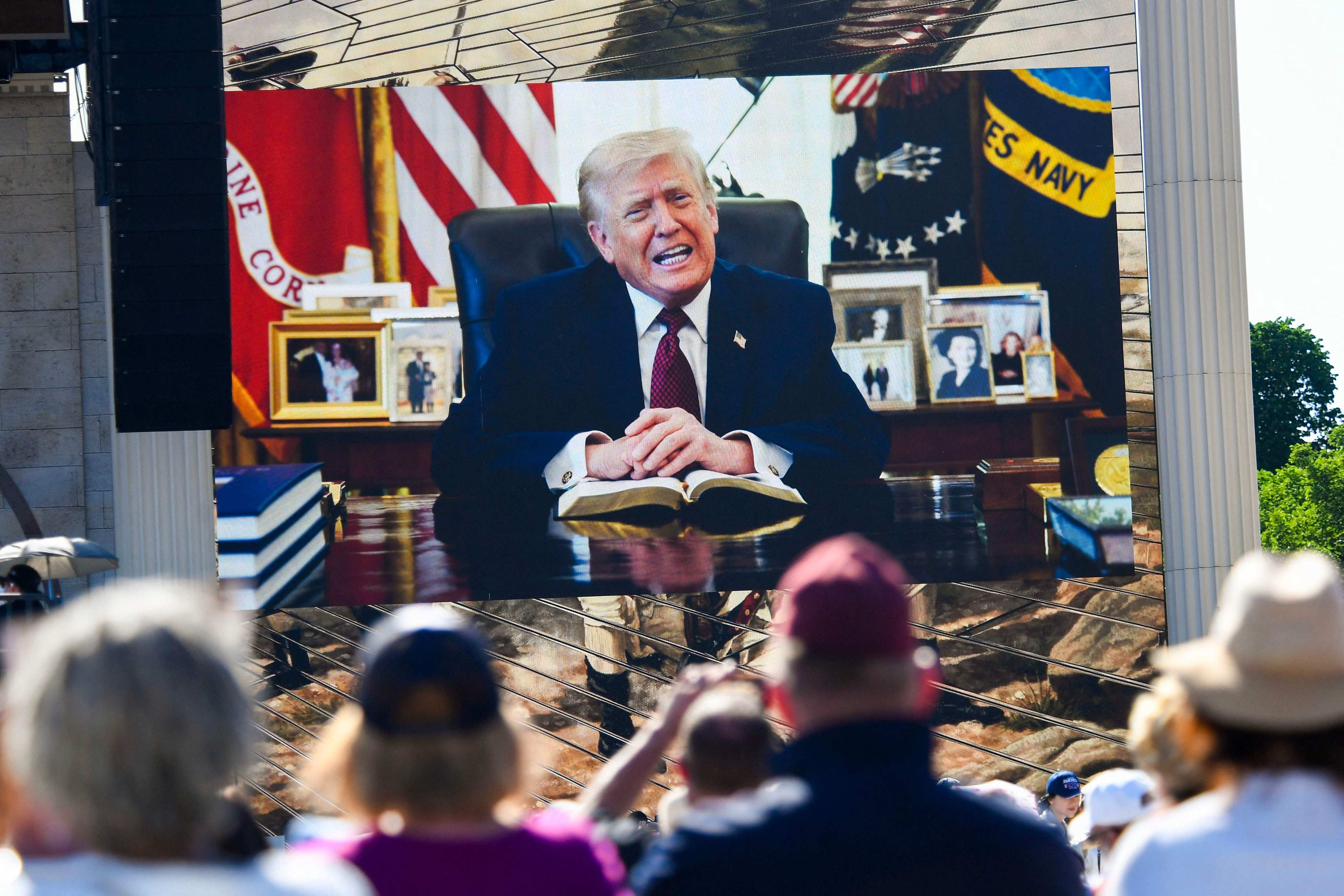Attendees watch a pre-recorded video of US President Donald Trump reading from the Bible during “Rededicate 250: A National Jubilee of Prayer, Praise and Thanksgiving” on the National Mall in Washington on Sunday. Photo: AFP