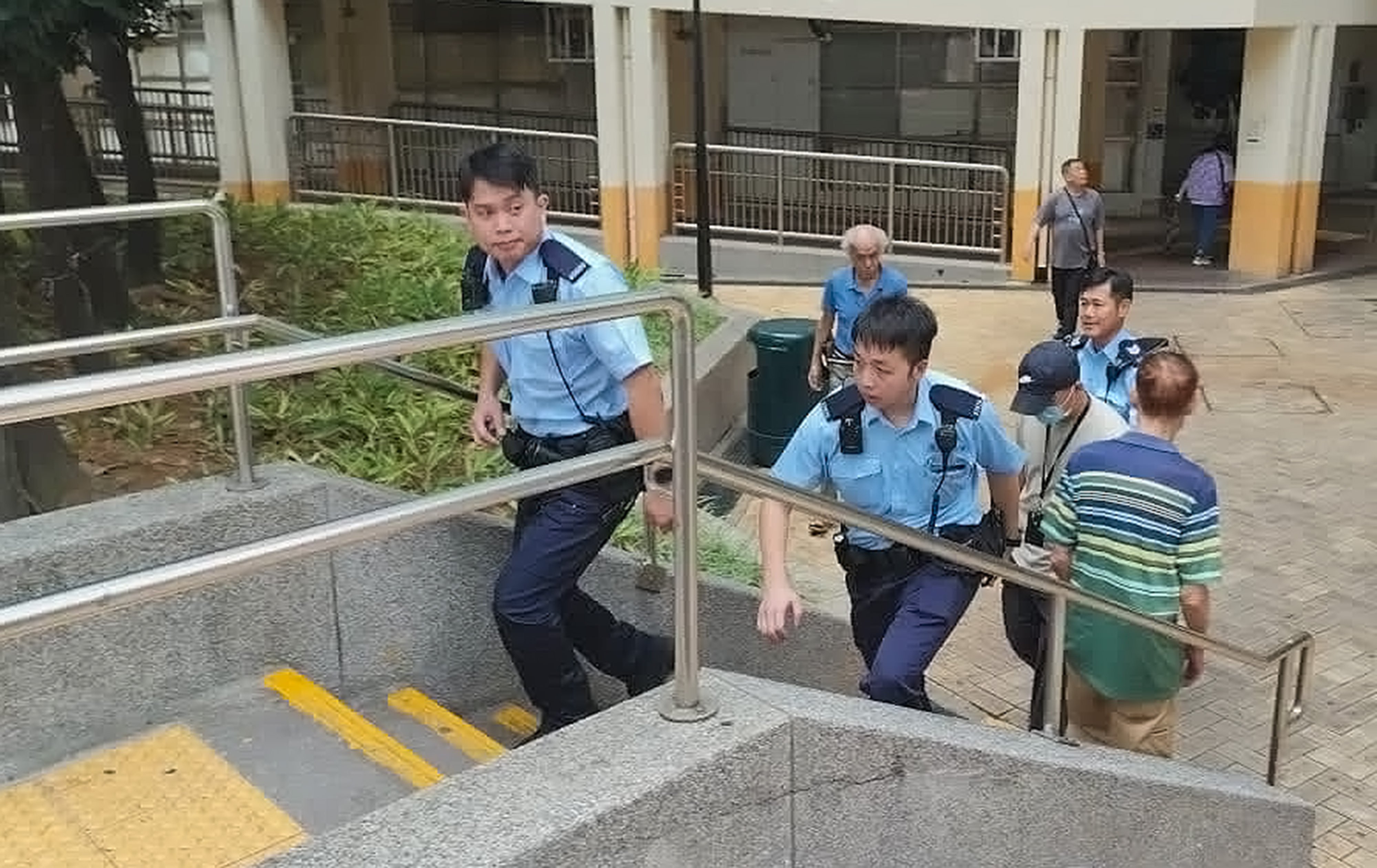 Policemen arrive at Fu Cheong Estate in Sham Shui Po, where a chronically ill woman was found dead inside a flat she shared with her mentally ill daughter. Photo: Handout
