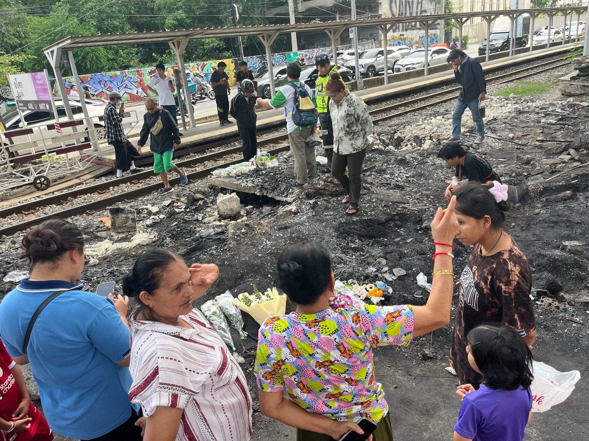 Bangkok residents gather at the site of Saturday’s deadly train crash. Photo: Aidan Jones
