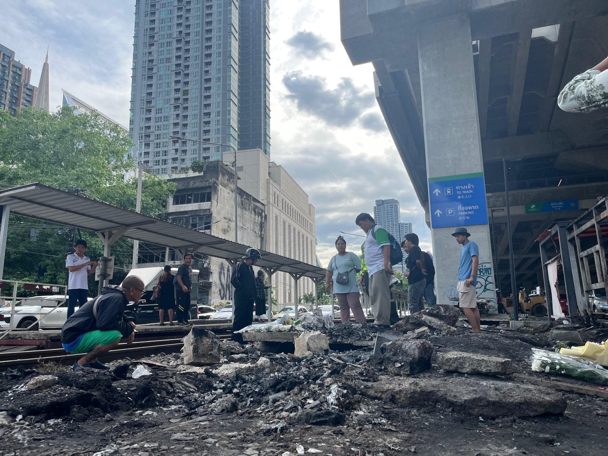 Bangkok residents gather at the site of Saturday’s deadly train crash. Photo: Aidan Jones