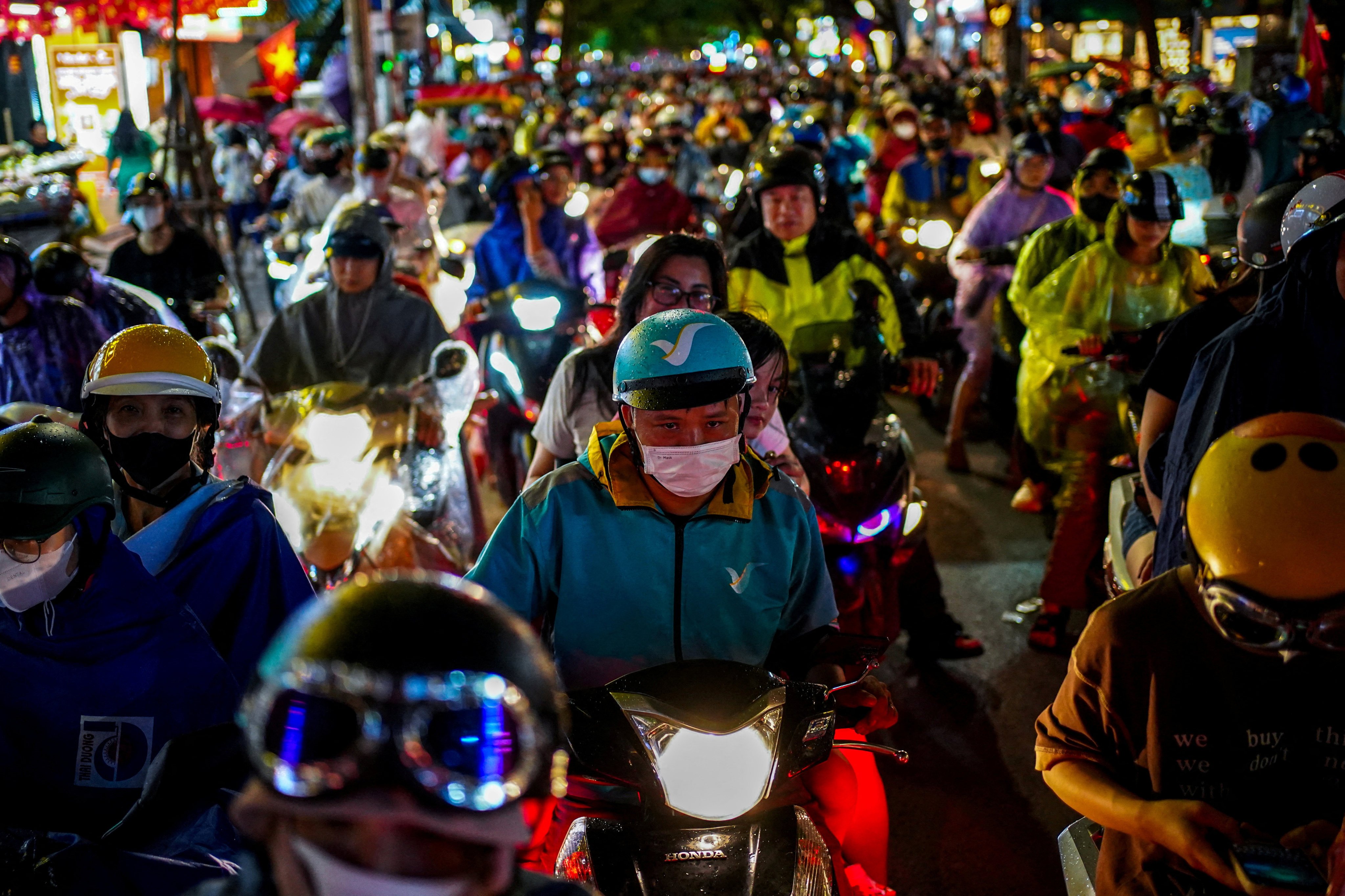 FILE PHOTO: People ride their motorbikes duing rush hour at Hanoi's Old Quarter, in Hanoi, Vietnam, August 30, 2025. REUTERS/Athit Perawongmetha/File Photo