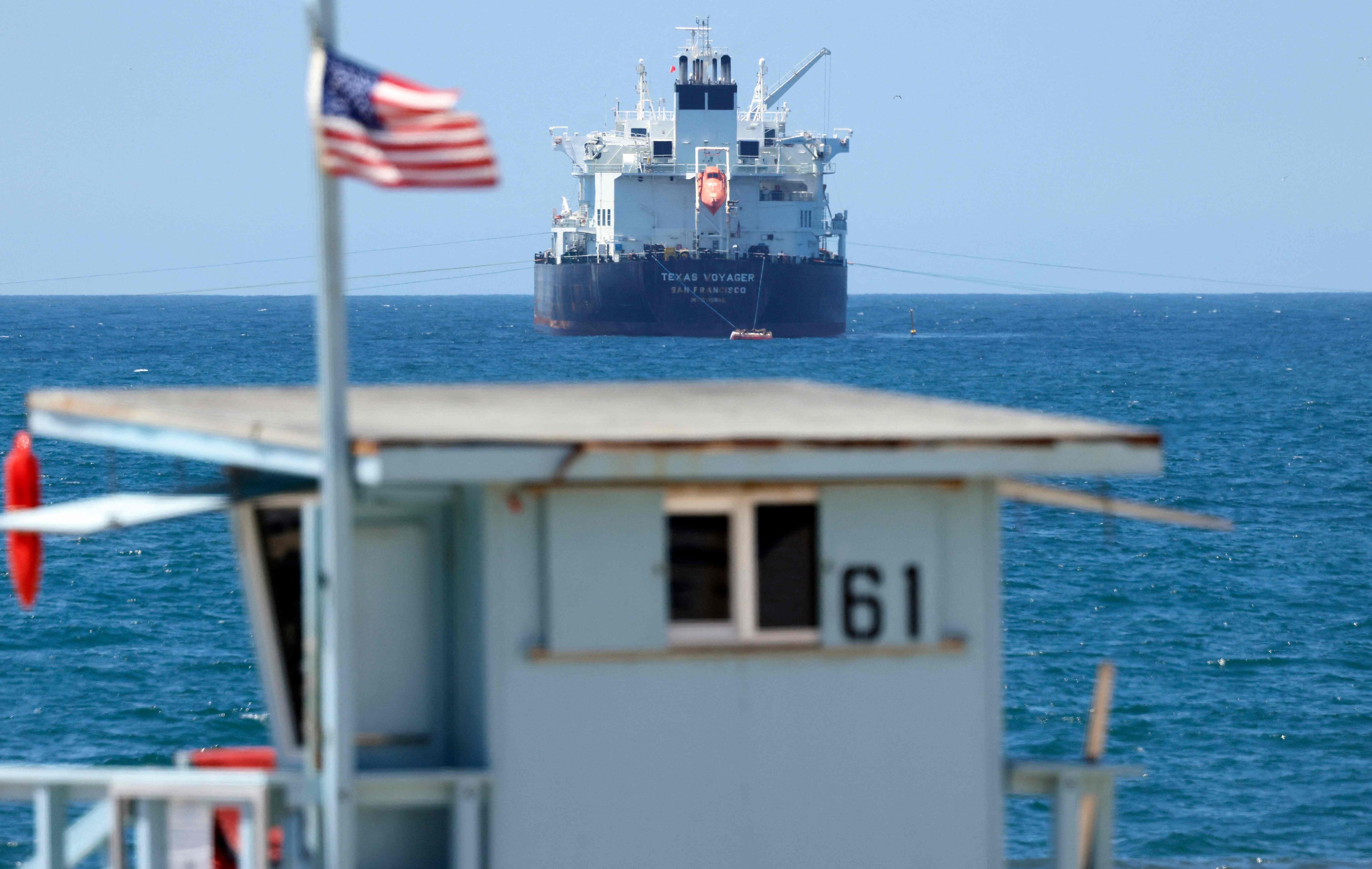 An American flag flies in front of the Texas Voyager oil and chemical tanker, anchored in the Pacific Ocean off the coast of the Chevron El Segundo refinery, on April 23. Photo: AFP