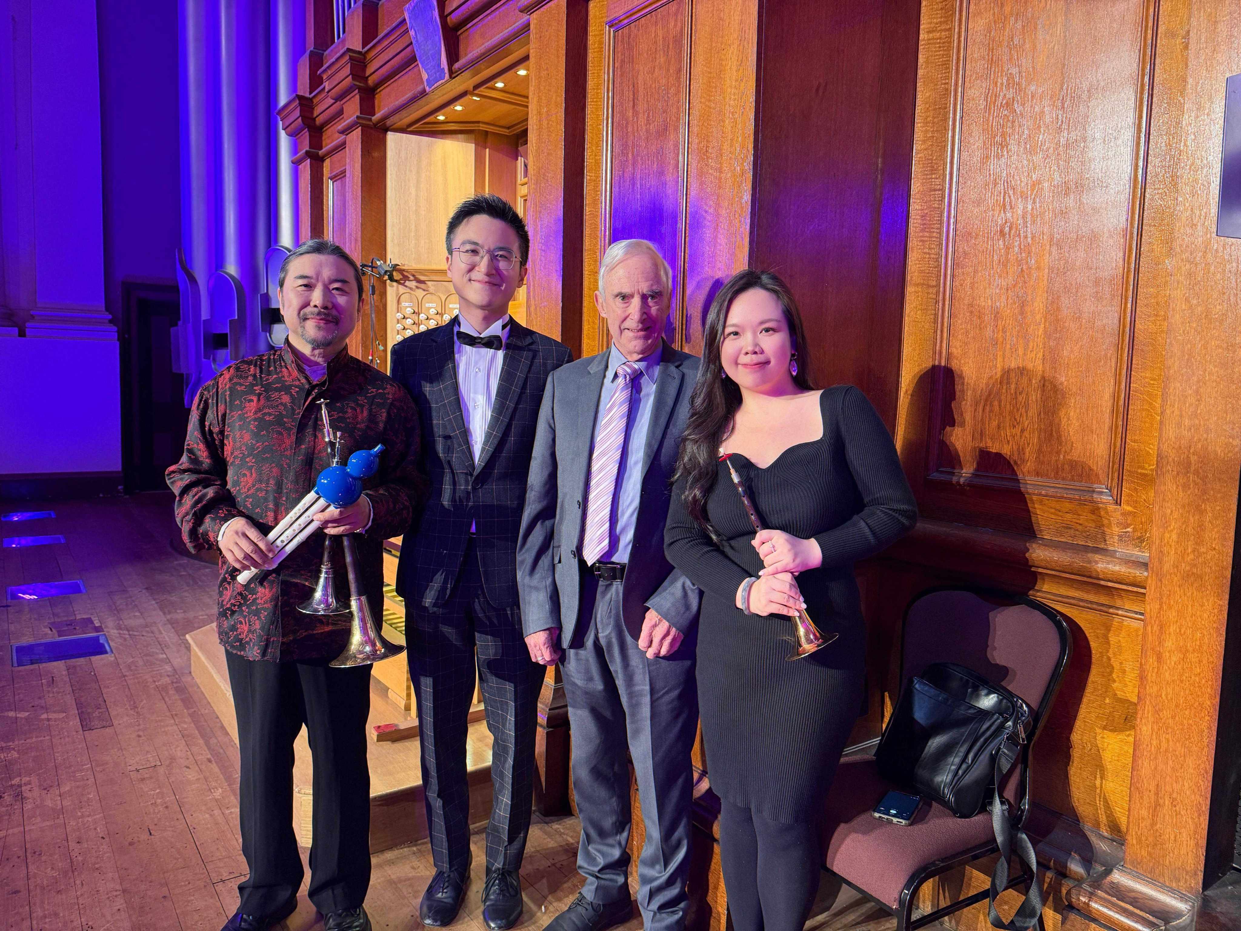 Organist Eric Chan (second left) and suona players Guo Yazhi (left) and Chrysoberyl Chan (right) are joined by Kerry Stevens, chairman of the Auckland Town Hall Organ, before a performance at the New Zealand venue under Chan’s “Pipe Organ Through East and West” programme  in May 2026. Photo: courtesy of Eric Chan.