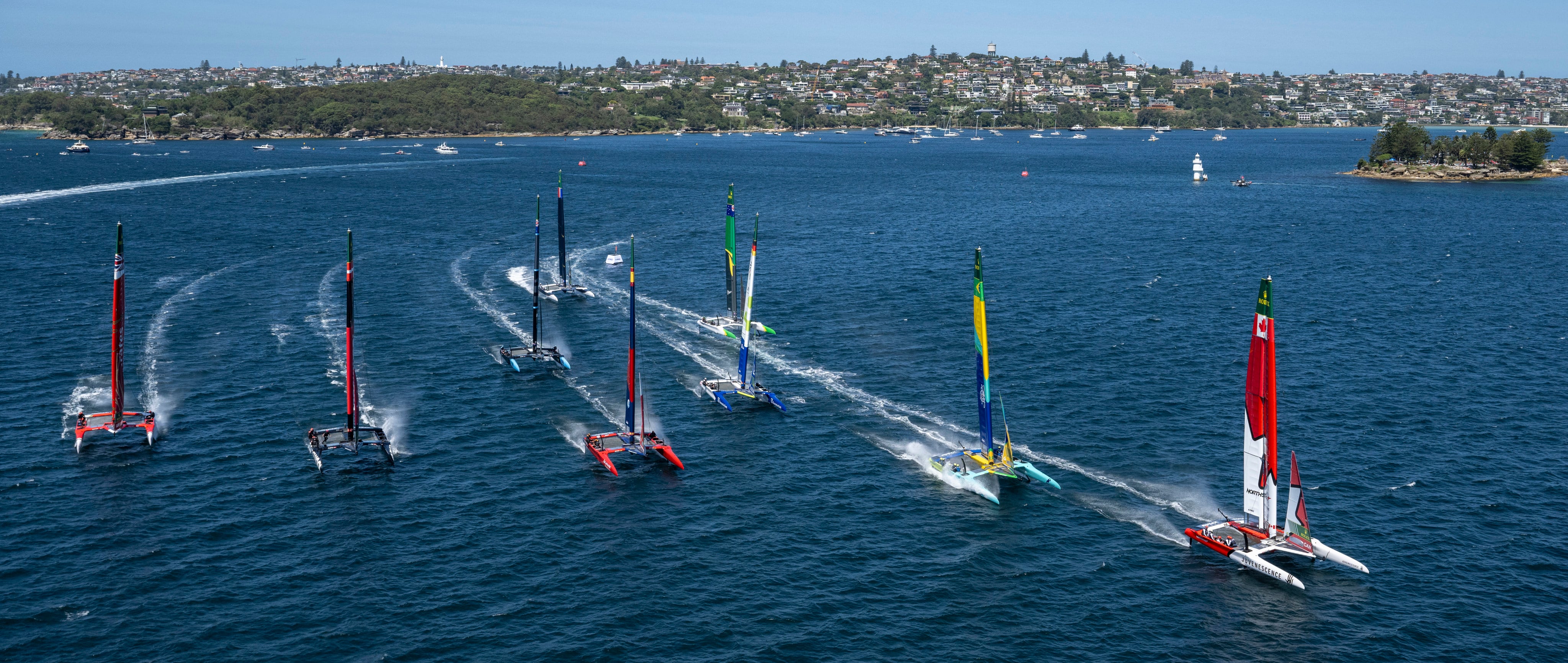 The Canada NorthStar team (right) leads the fleet during a practice run ahead of the 2025 Australia SailGP event in Sydney. Photo: SailGP
