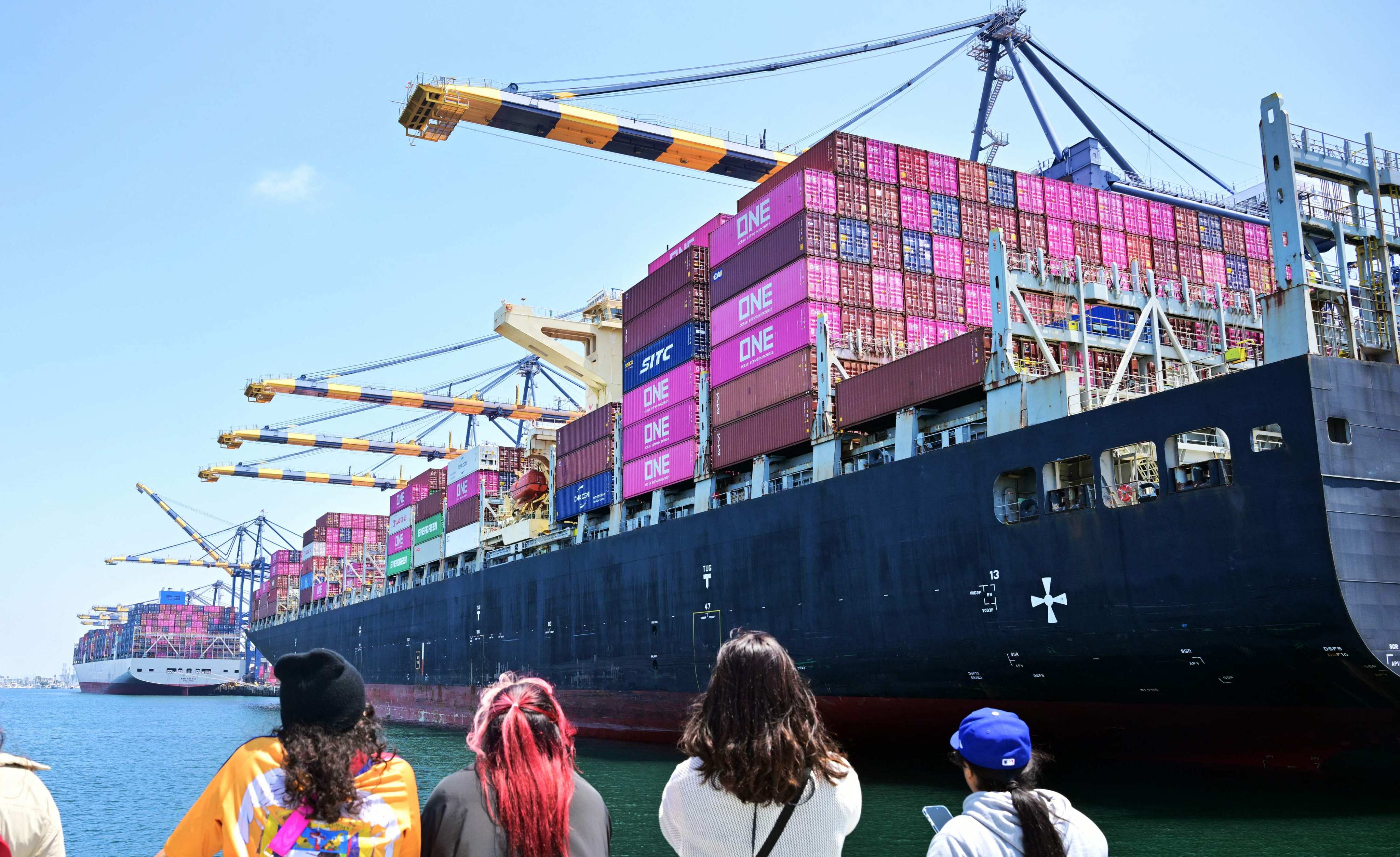 People watch freight ships full of containers at the Port of Los Angeles, California, on May 9. Photo: AFP