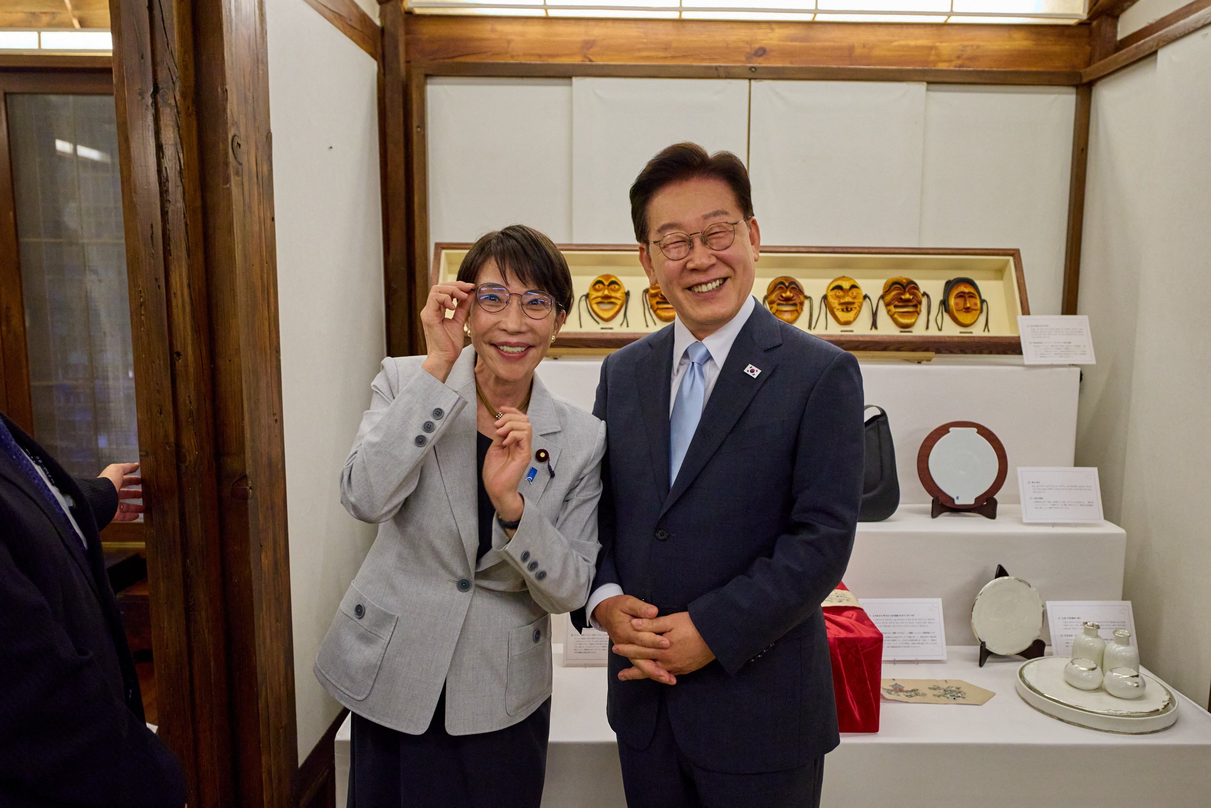 Japanese Prime Minister Sanae Takaichi poses for photographs after receiving a gift of glasses from South Korean President Lee Jae Myung in Andong, South Korea, on Tuesday. Photo: South Korean Presidential Office/Yonhap/Reuters