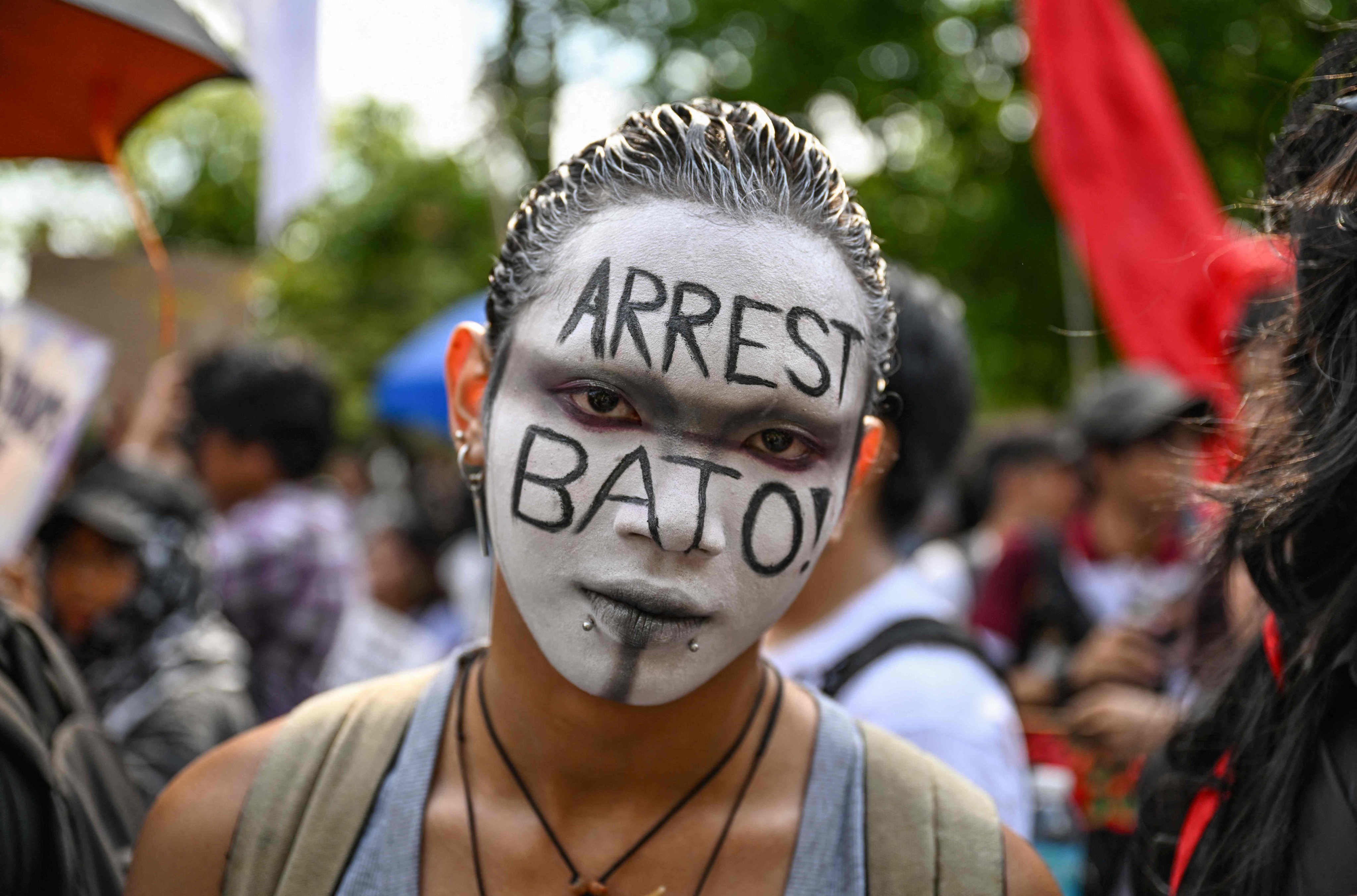 A protester calls for the arrest of Philippine Senator Ronald “Bato” dela Rosa during a demonstration on Monday. Photo: AFP