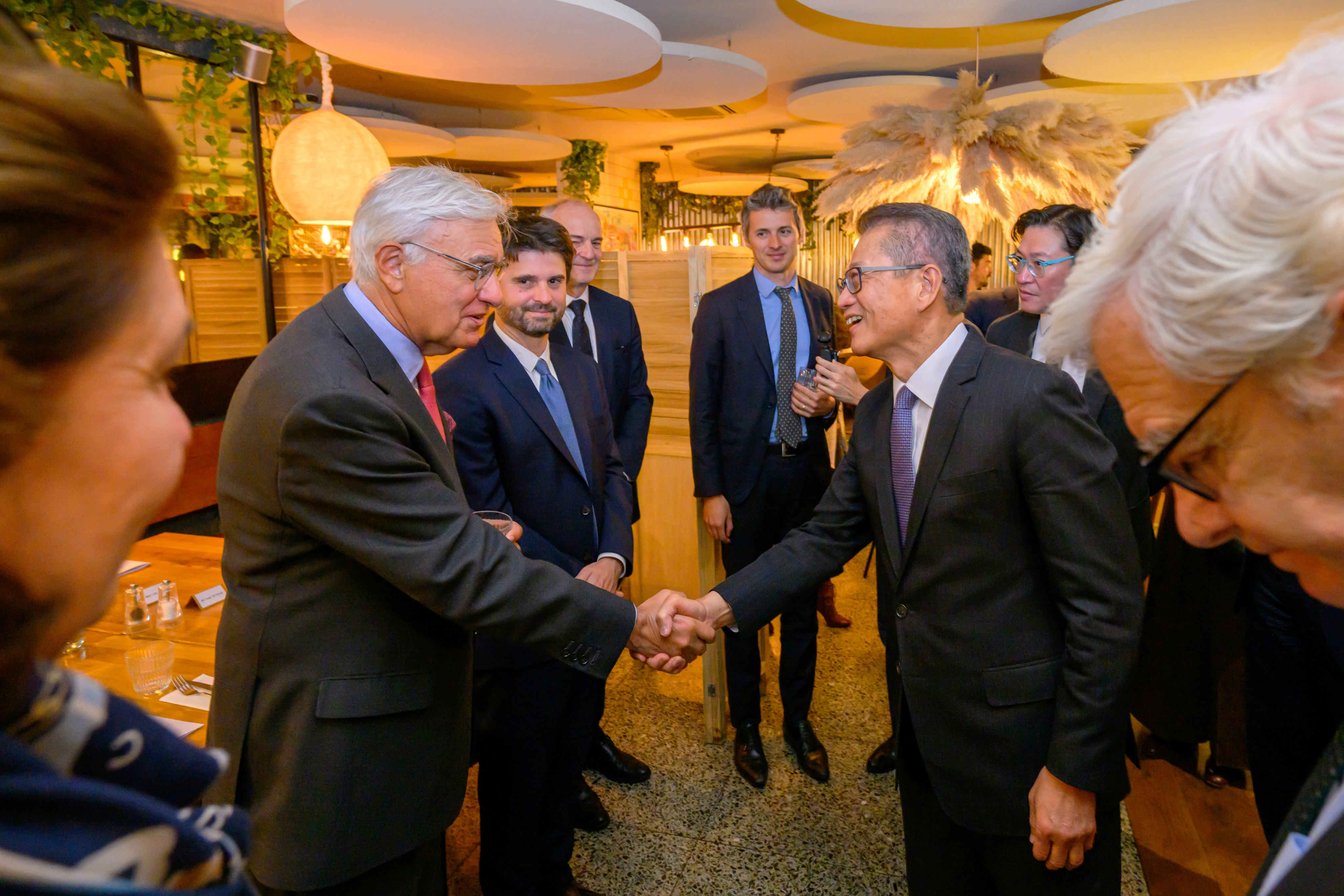 Paul Chan (right) meets local banking and finance leaders in Paris Photo: ISD