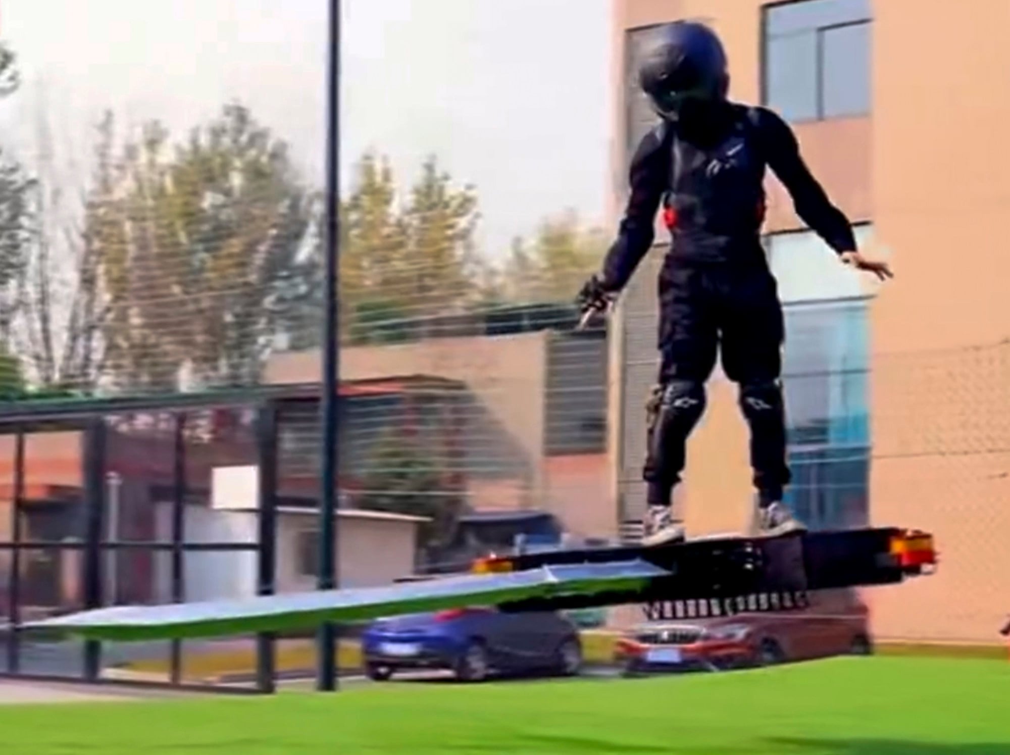 A helmeted man in black balances on the hi-tech flying sword. Photo: Sina