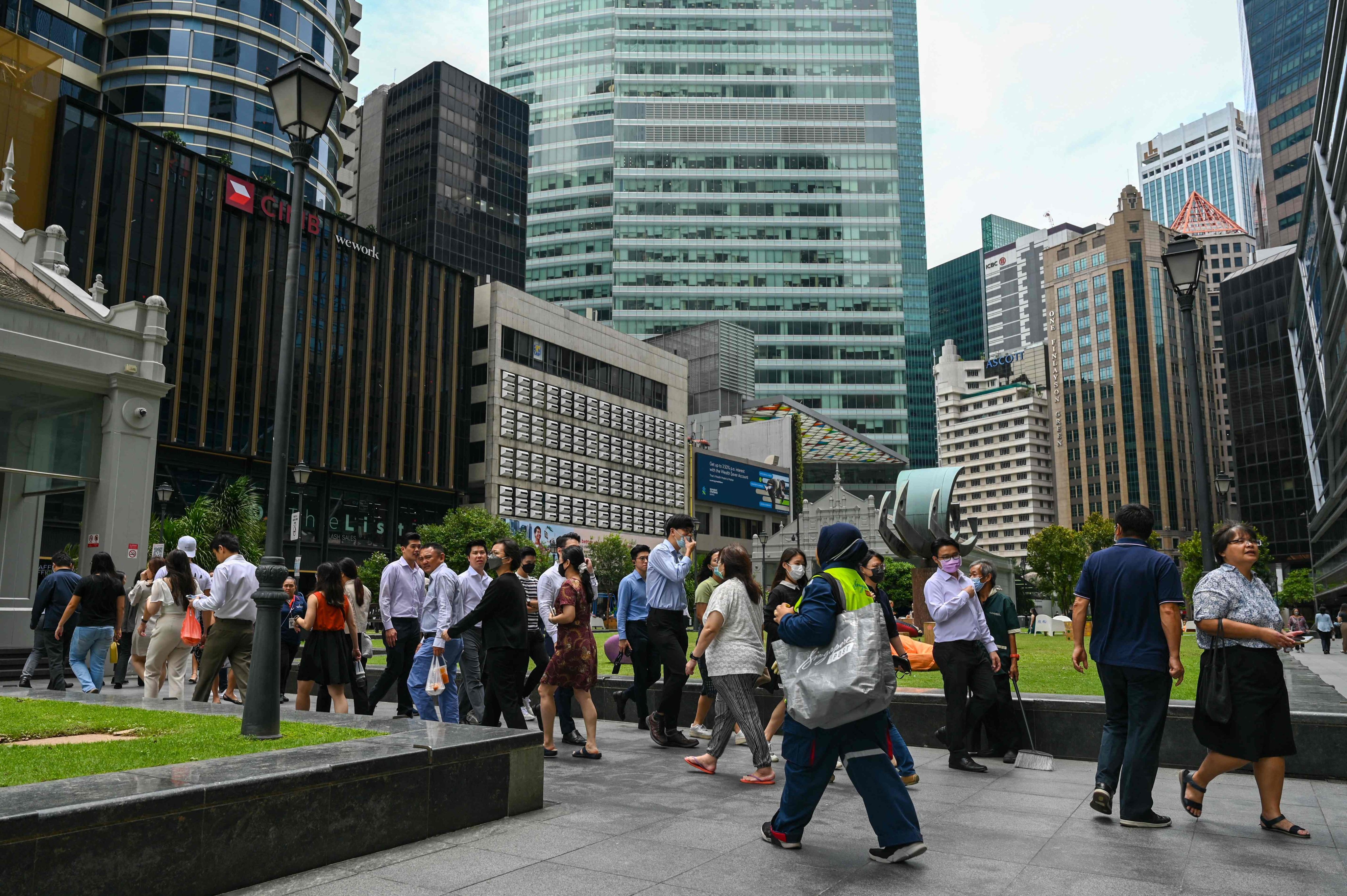 Office workers at the Raffles Place financial business district. Singapore has unveiled various measures to help workers cope with AI disruption. Photo: AFP