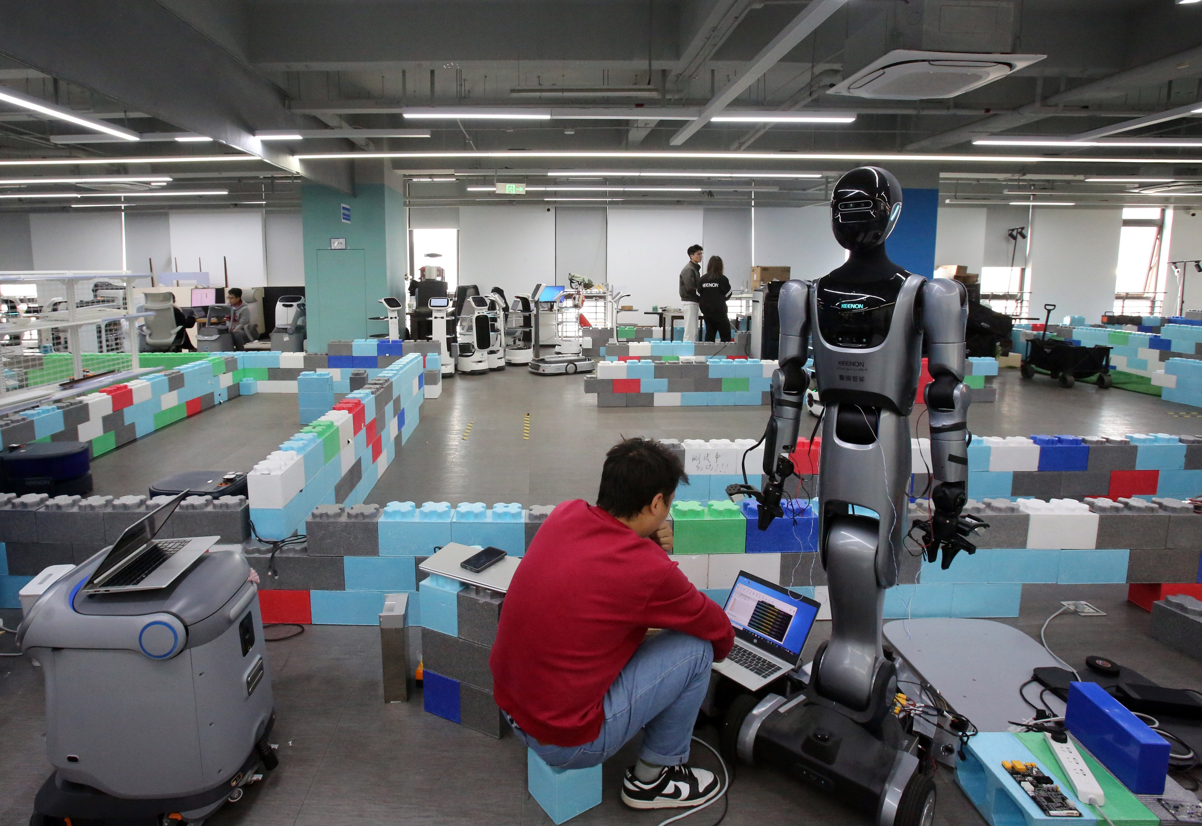 A staff member of Keenon Robotics debugs a humanoid robot in Pudong, Shanghai, on April 2. The robotics industry has attracted private equity interest in China. Photo: Xinhua