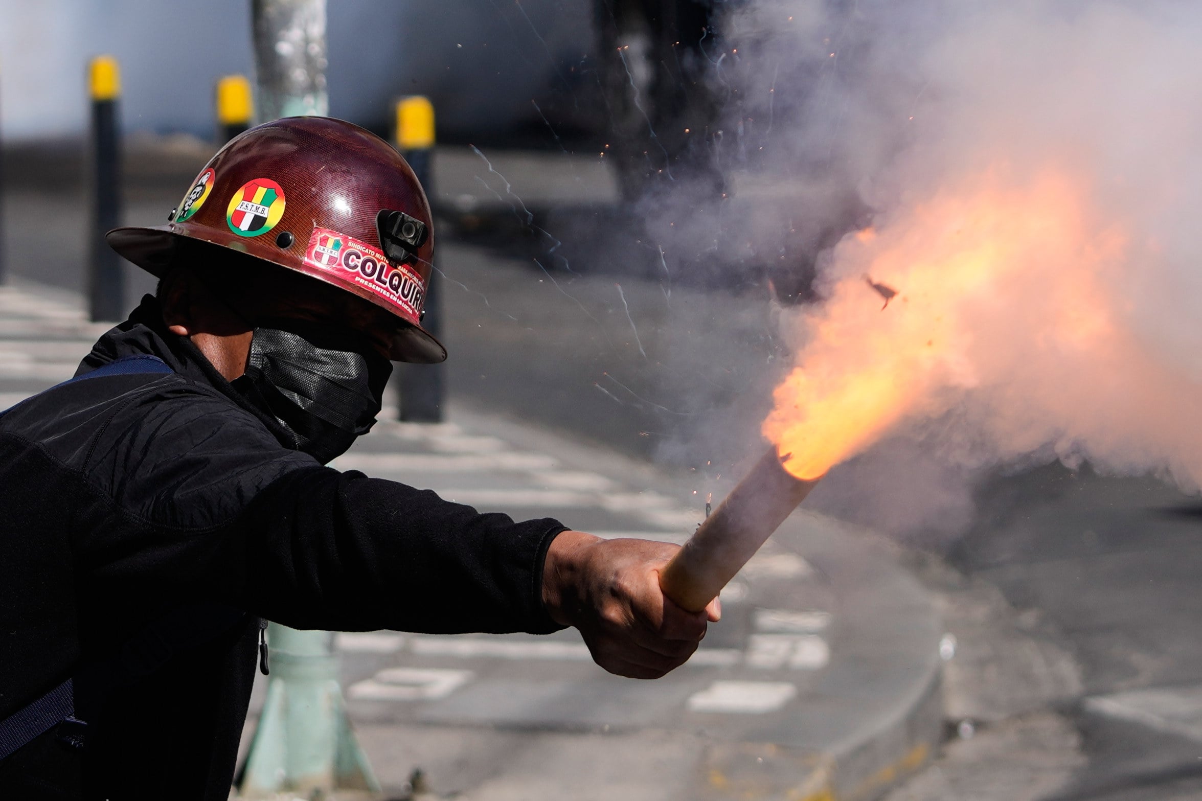 A miner launches a firecracker at police during an anti-government protest in La Paz. Photo: AP