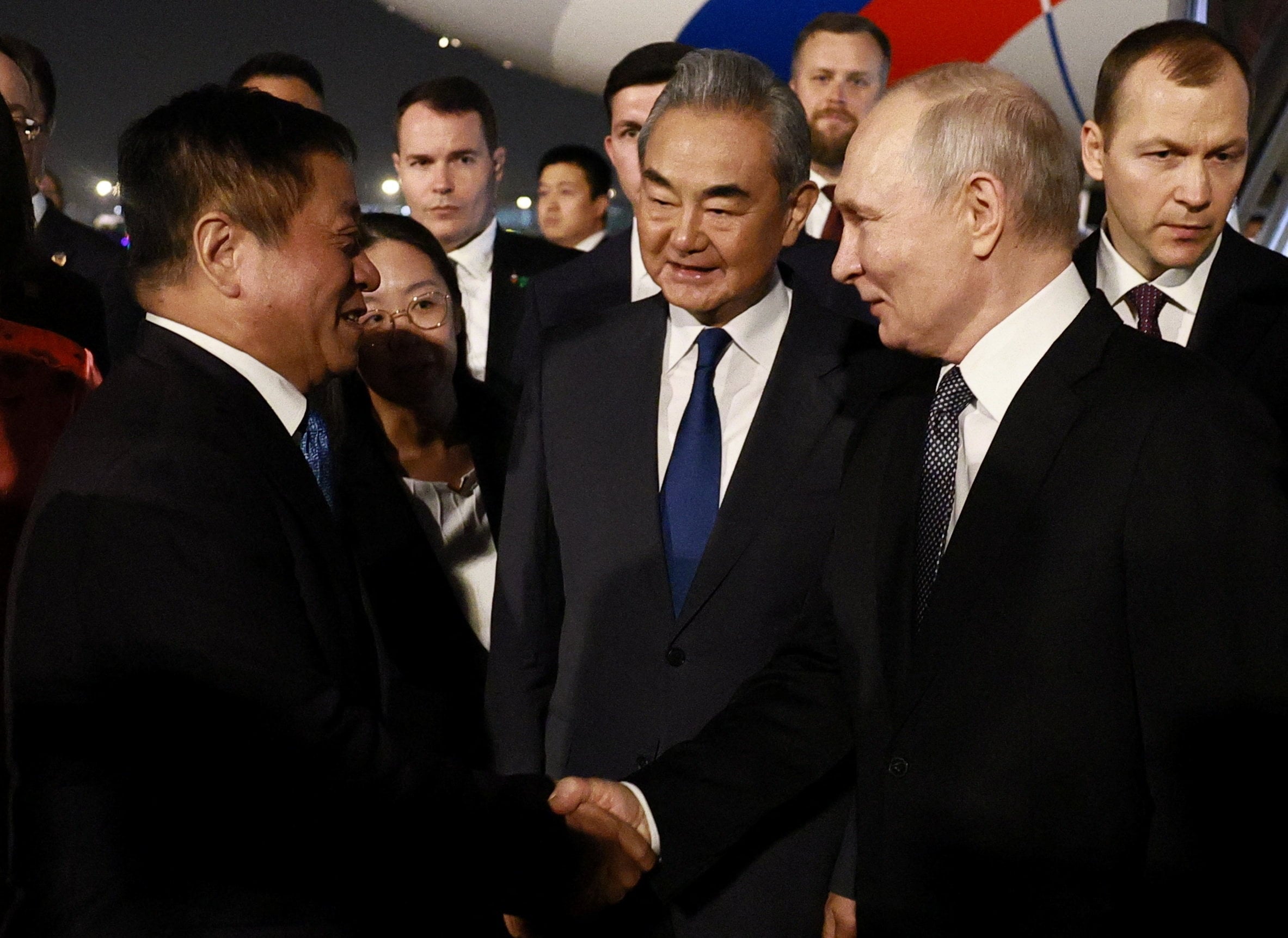 Russian President Vladimir Putin greets Chinese officials, including Foreign Minister Wang Yi, during a welcoming ceremony upon arrival in Beijing. Photo: Sputnik via Reuters