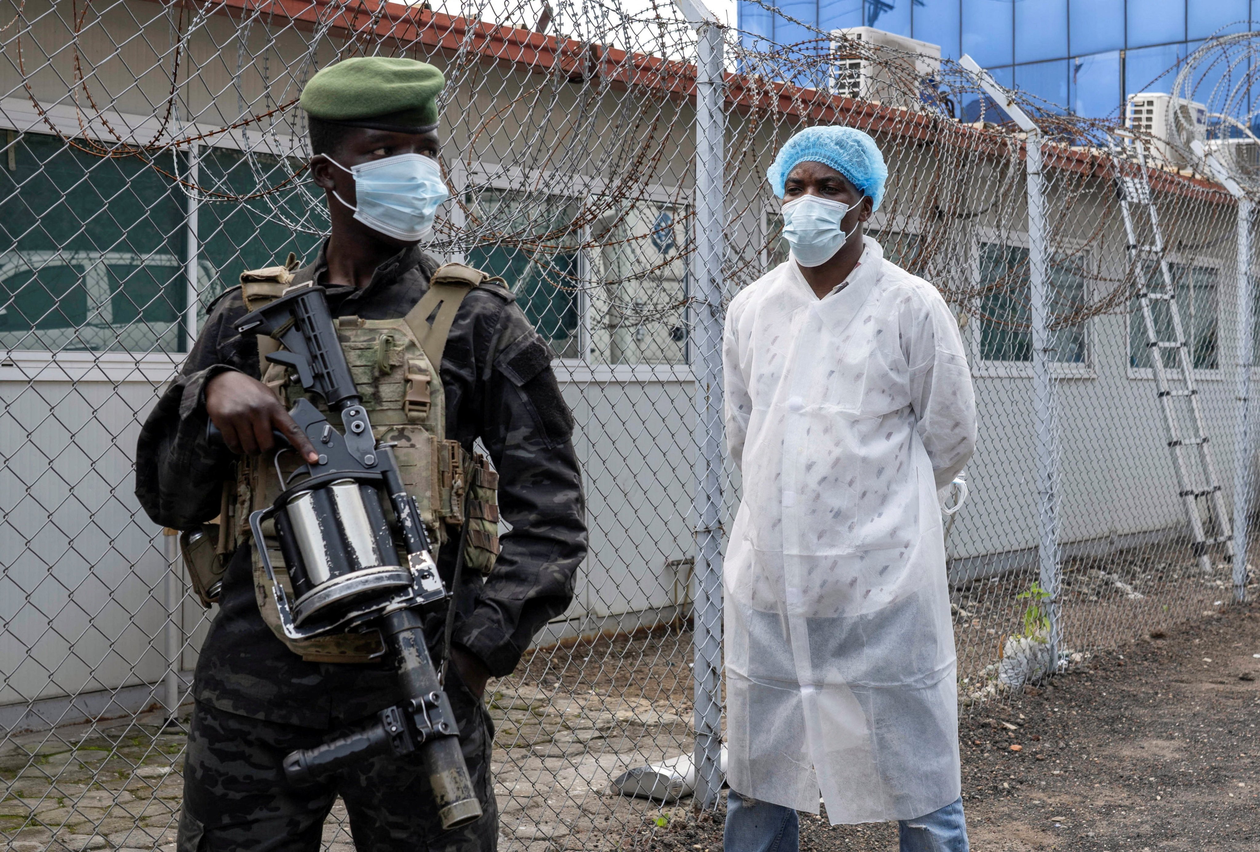 An armed M23 rebel guards the Rodolphe Merieux Laboratory in Goma, DR Congo, where suspected cases of the rare Ebola strain are being tested. Photo: Reuters