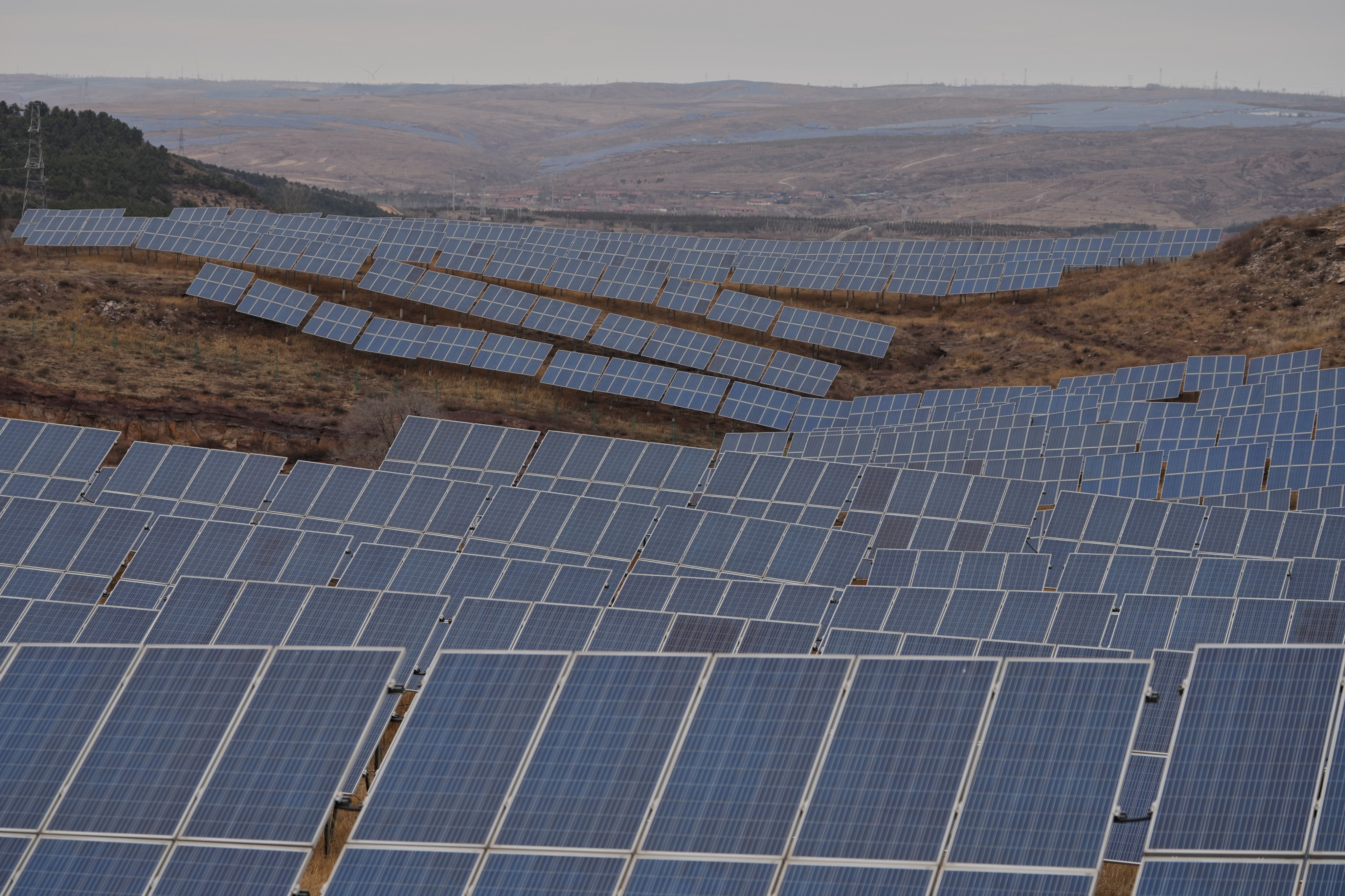 Rows of solar panels are seen at a photovoltaic farm in Datong, China. Photo: AP