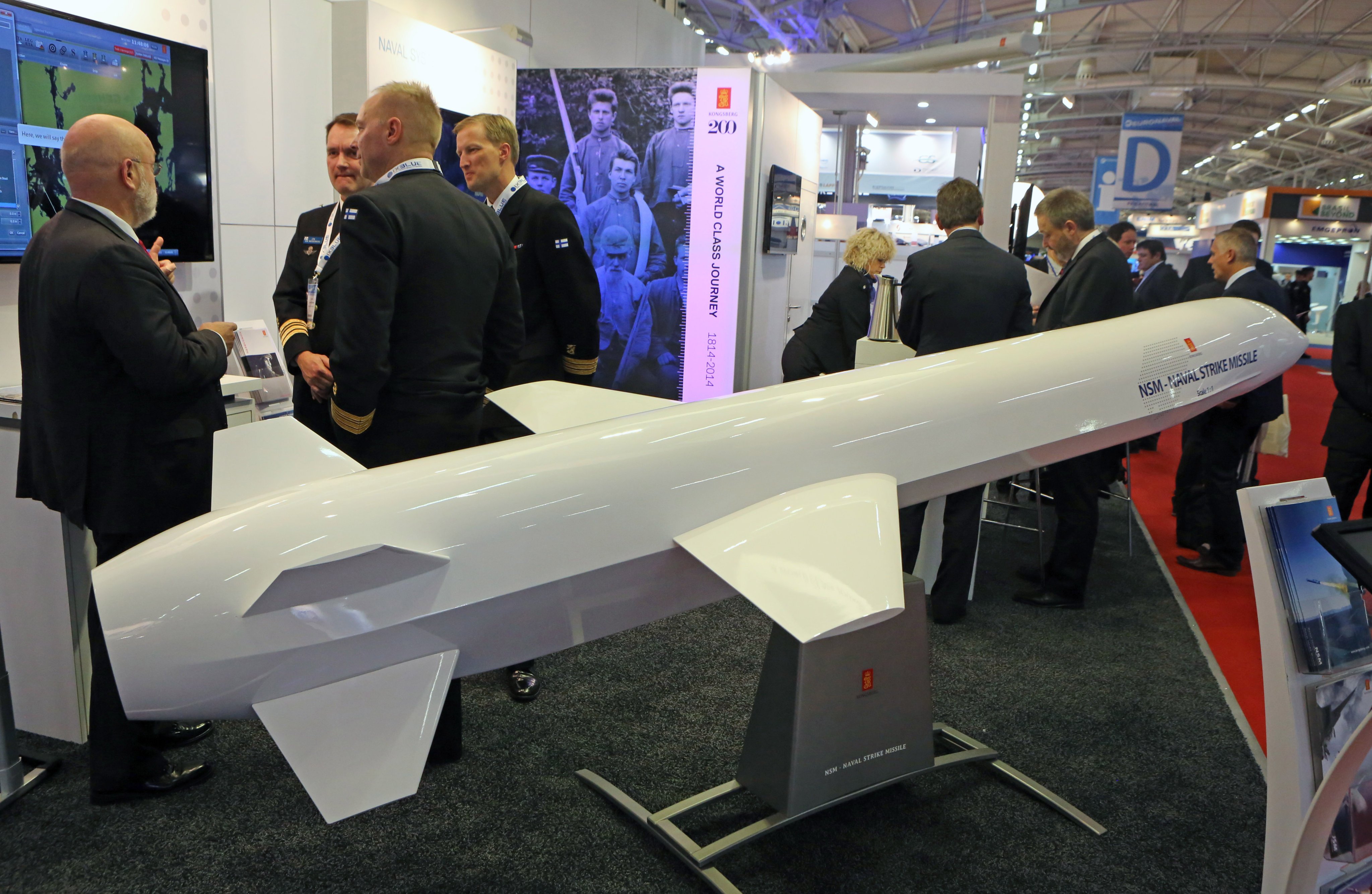 Visitors gather next to a display of an NSM Naval Strike Missile made by Norwegian company Kongsberg, at the Euronaval show, in Le Bourget, France in 2014. Photo: AP