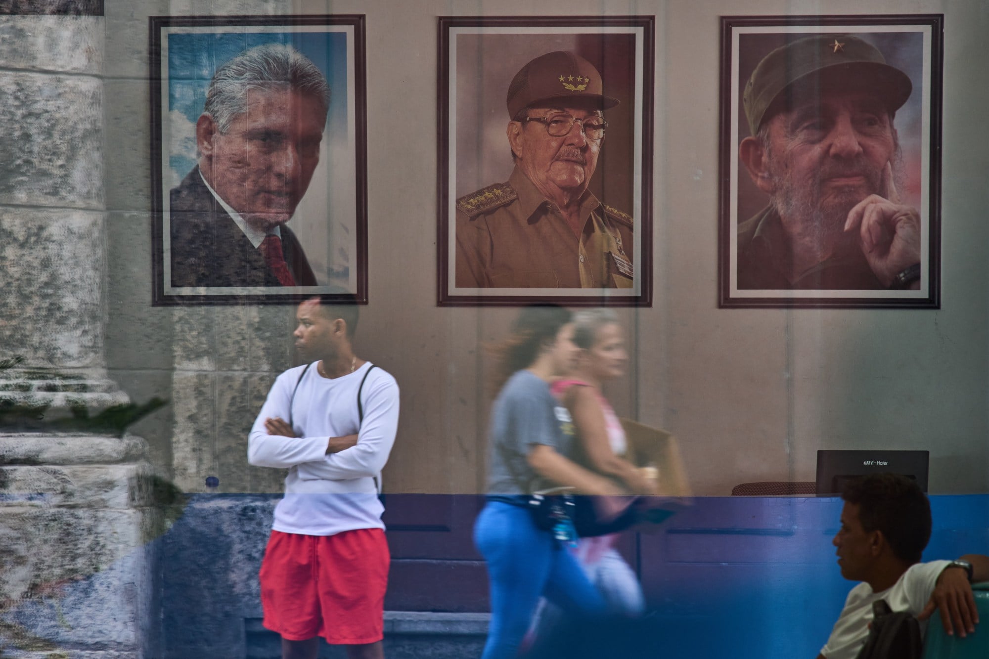 Images of Cuba’s President Miguel Diaz-Canel, Raul Castro and Fidel Castro at the state building in Havana. Photo: AP