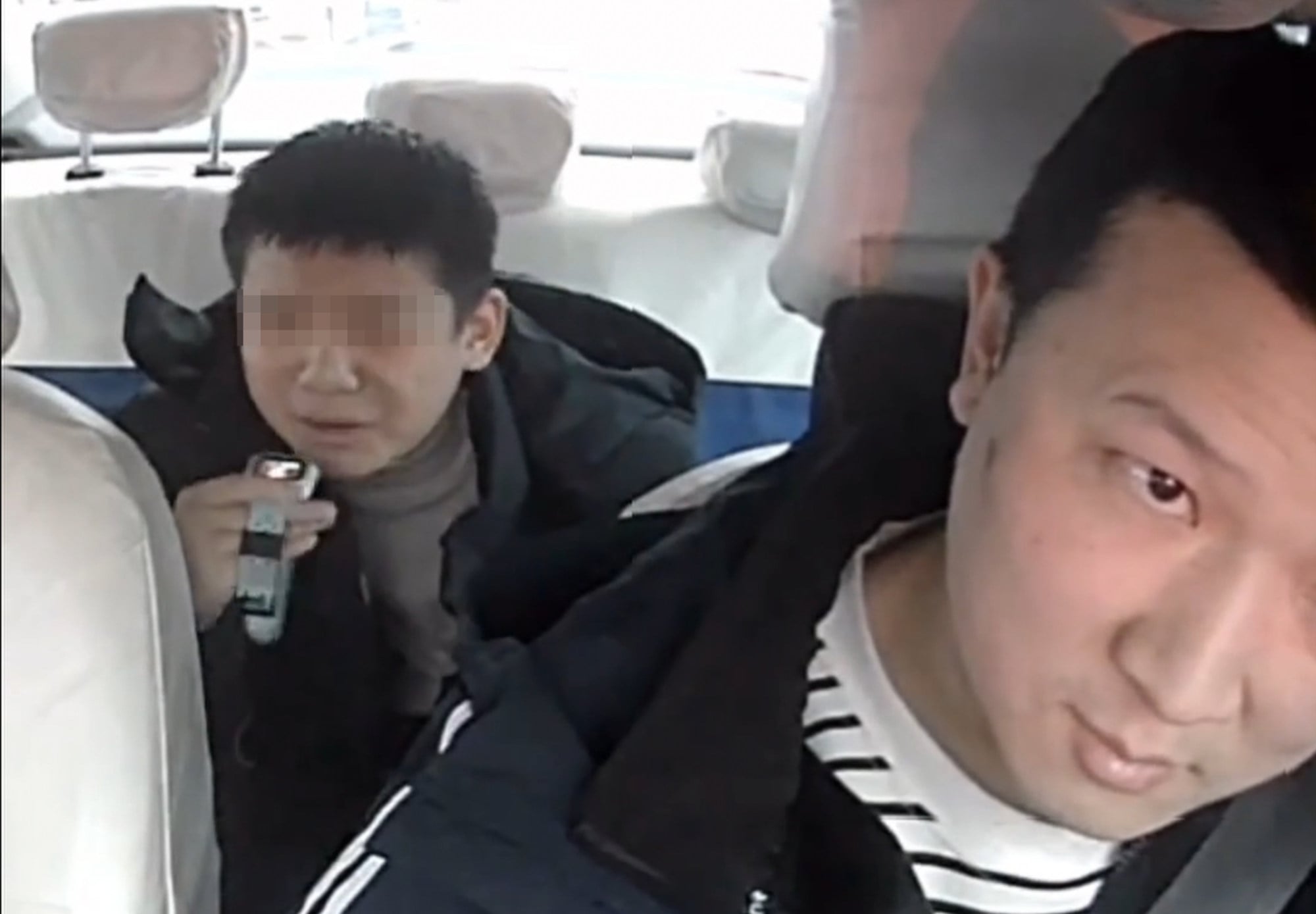 An image from the taxi’s surveillance camera shows the boy calling his mother as the driver looks in the rear-view mirror. Photo: Douyin