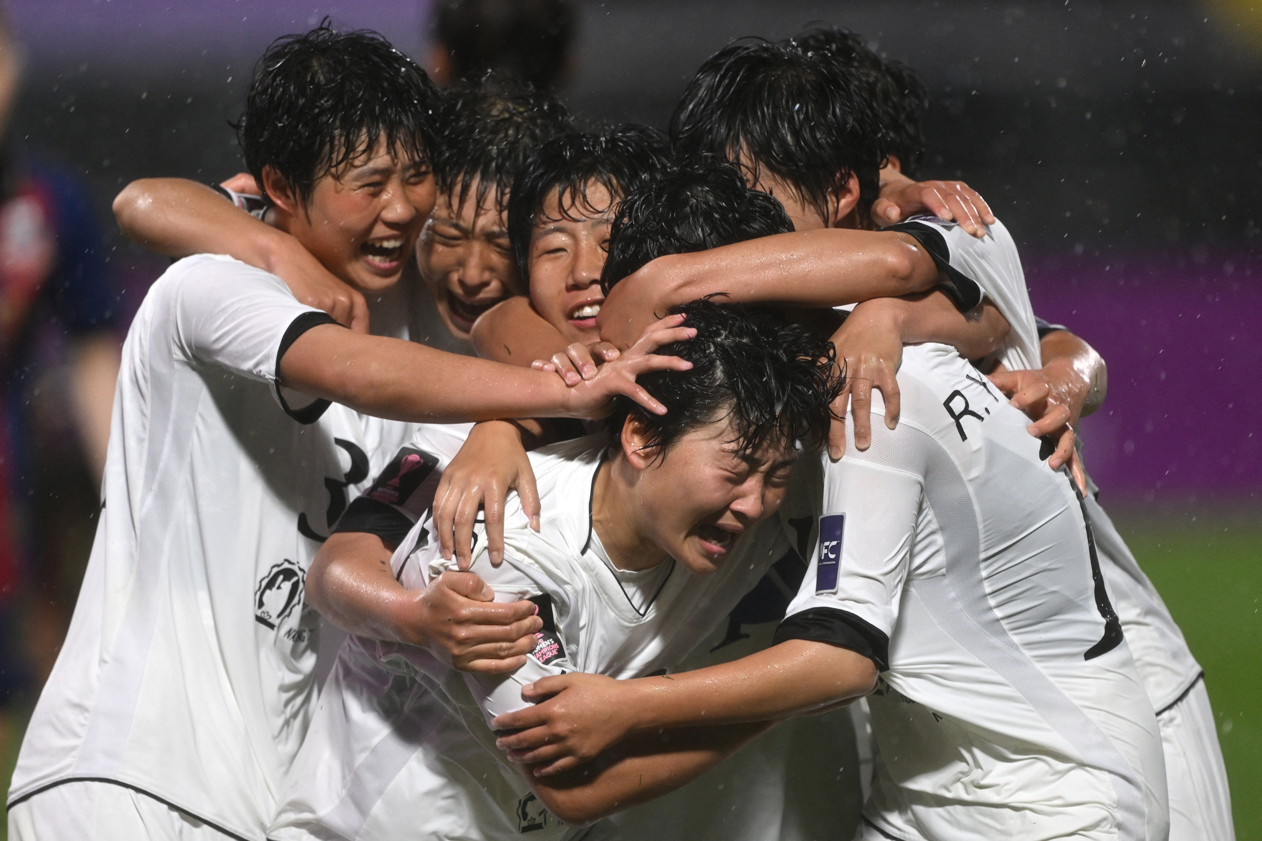 Kim Kyong Yong (C #17) of Naegohyang Women’s FC celebrates scoring her team’s second goal with teammates during the AFC Women’s Champions League semi-final football match between North Korea’s Naegohyang Women’s FC and South Korea’s Suwon FC Women in Suwon on May 20, 2026. (Photo by Jung Yeon-je / AFP)