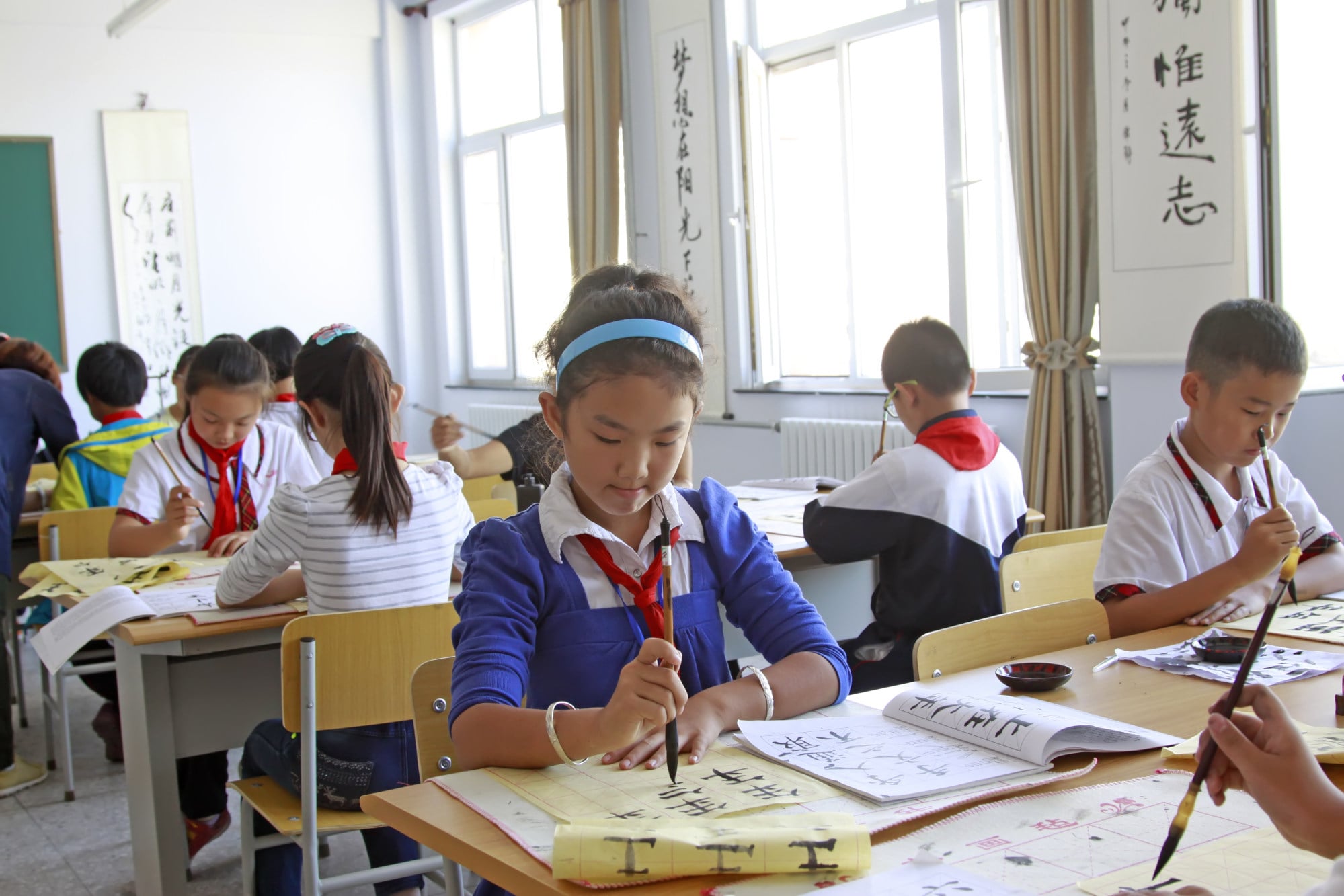 Chinese primary school pupils concentrate in a calligraphy class. Photo: Shutterstock Chinese primary school pupils concentrate in a calligraphy class. Photo: Shutterstock