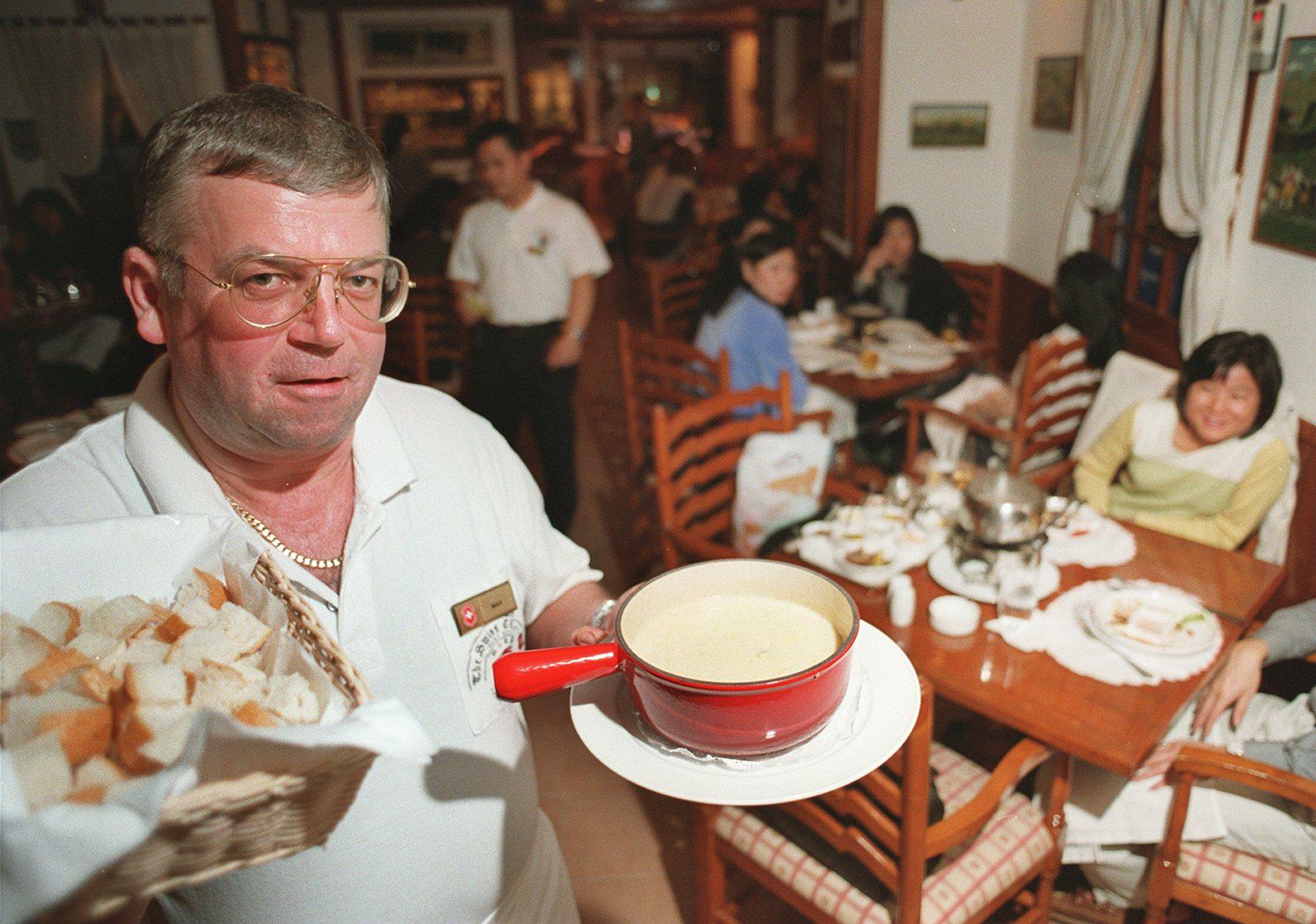 The Swiss Chalet’s Lax Liechti serves cheese fondue to guests at the restaurant in Tsim Sha Tsui, Hong Kong, in February 1999. Photo: SCMP
