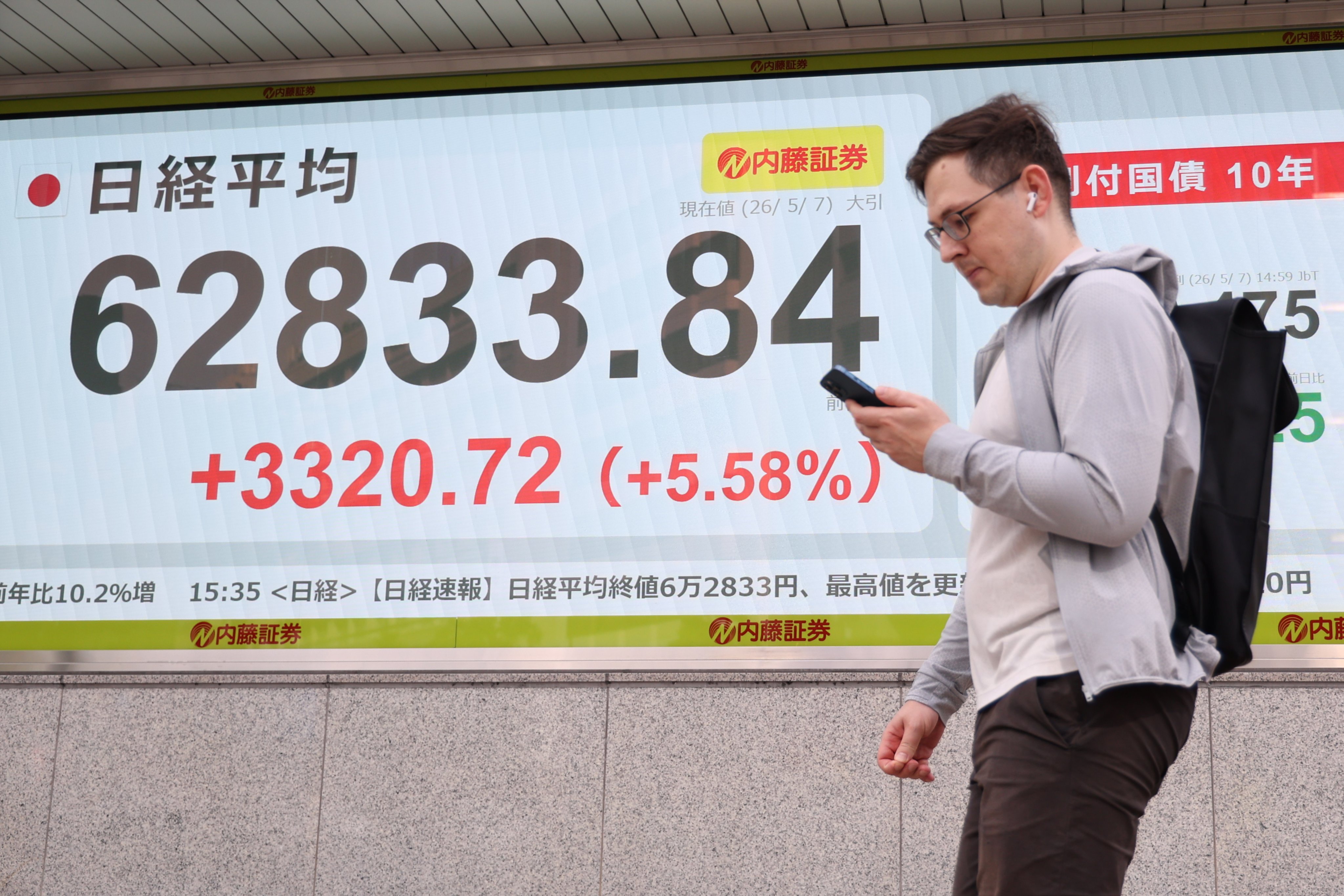 A man walks past a digital stock display in Tokyo on May 7. Photo:  EPA