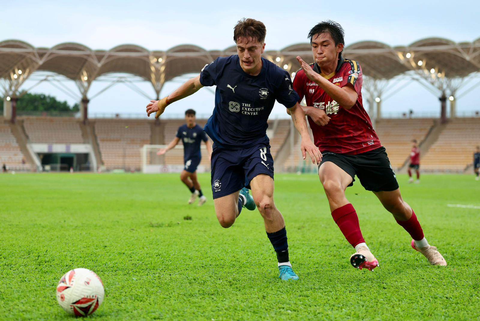 Dominic Johns leads a chase for possession in Football Club’s draw with Kowloon City last week. Photo: Alan Man