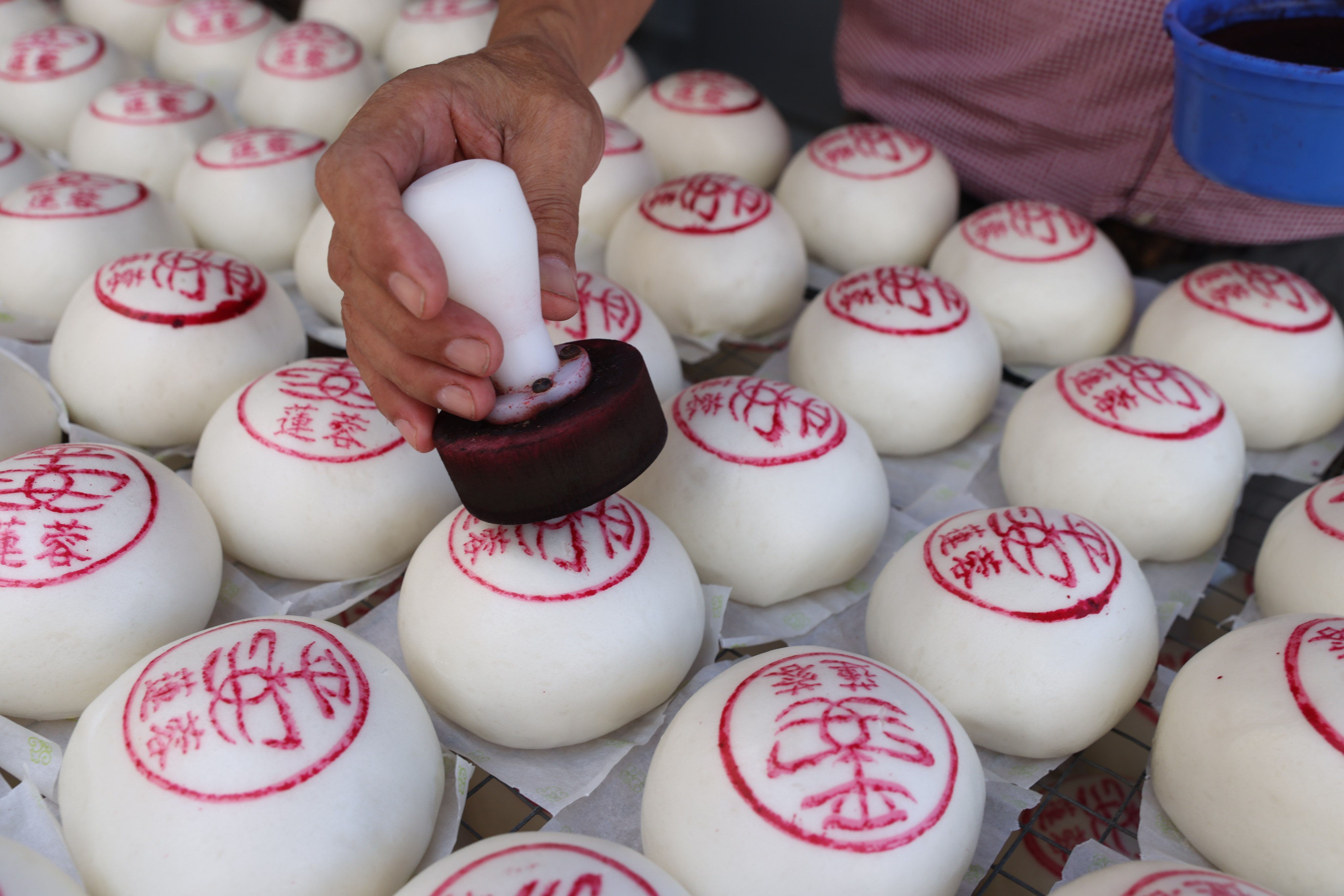 An employee of Kwok Kam Kee, a bakery on Hong Kong’s Cheung Chau island, prepares traditional ping on bao, or “peace buns”, ahead of the annual Cheung Chau Bun Festival. Photo: Yik Yeung-man