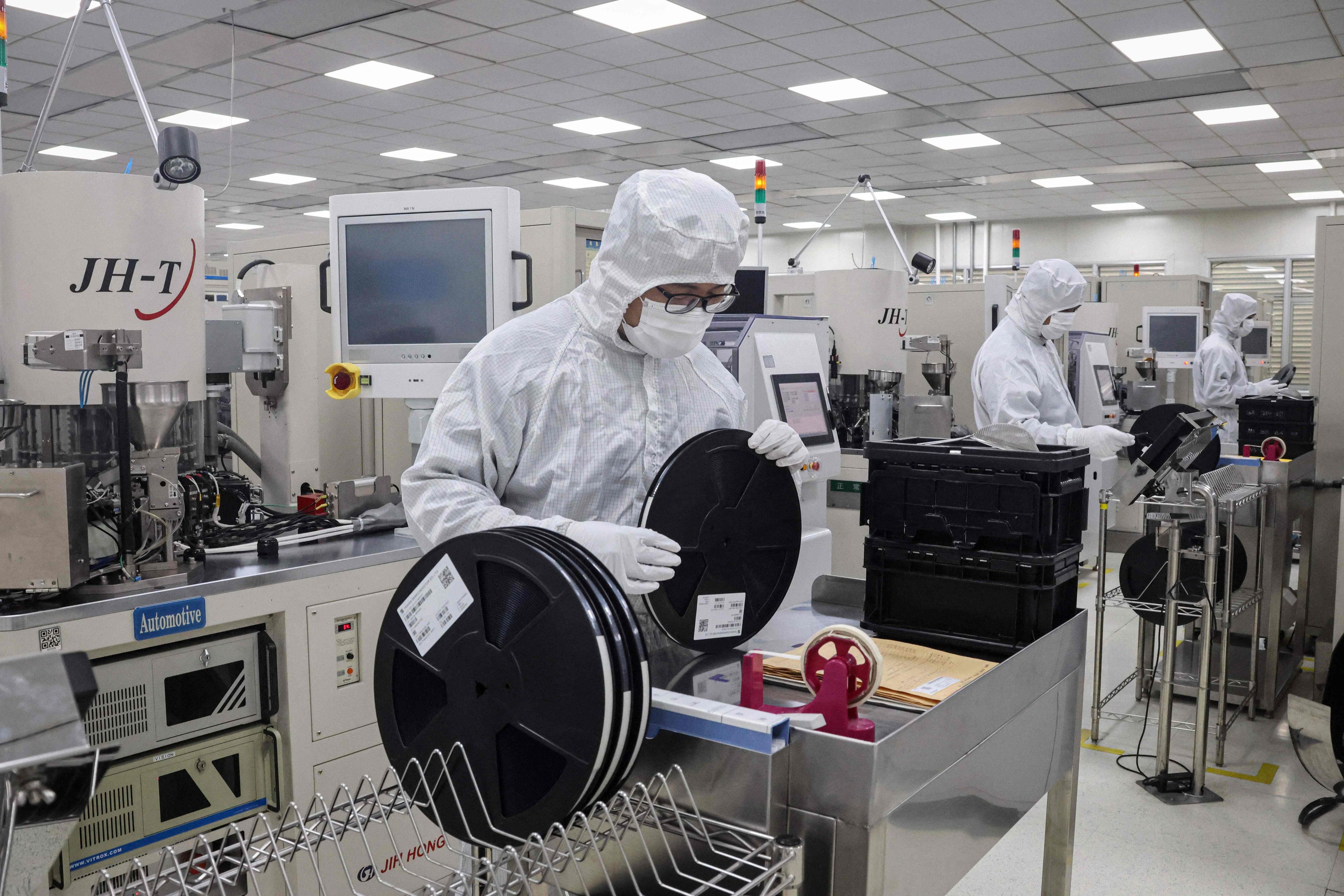 Employees work at a semiconductor factory in China’s Shandong province. Some of the nation’s struggling property developers have announced investments in the chipmaking sector. Photo: AFP