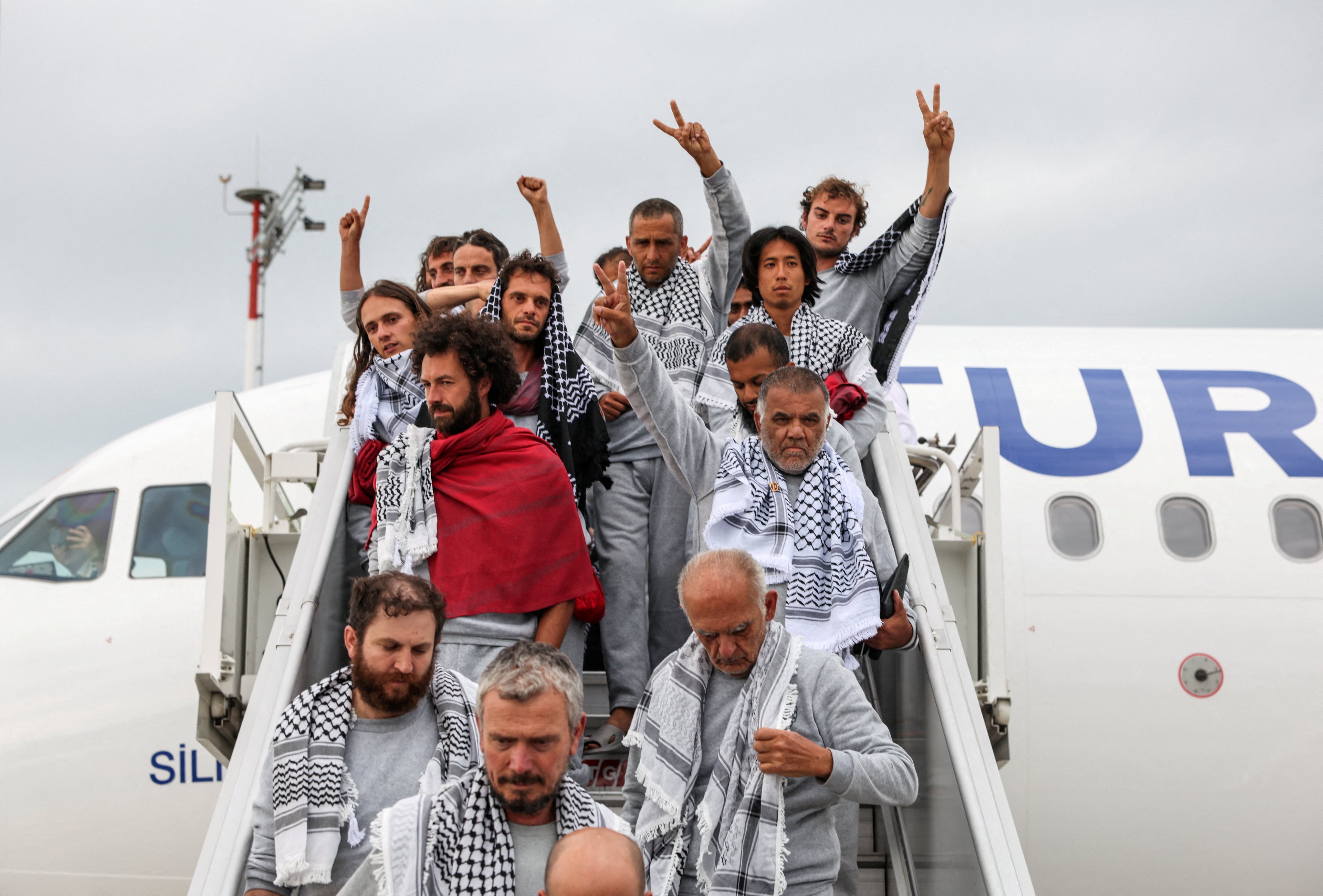 Activists disembark from a plane upon arrival at Istanbul Airport. Photo: Reuters