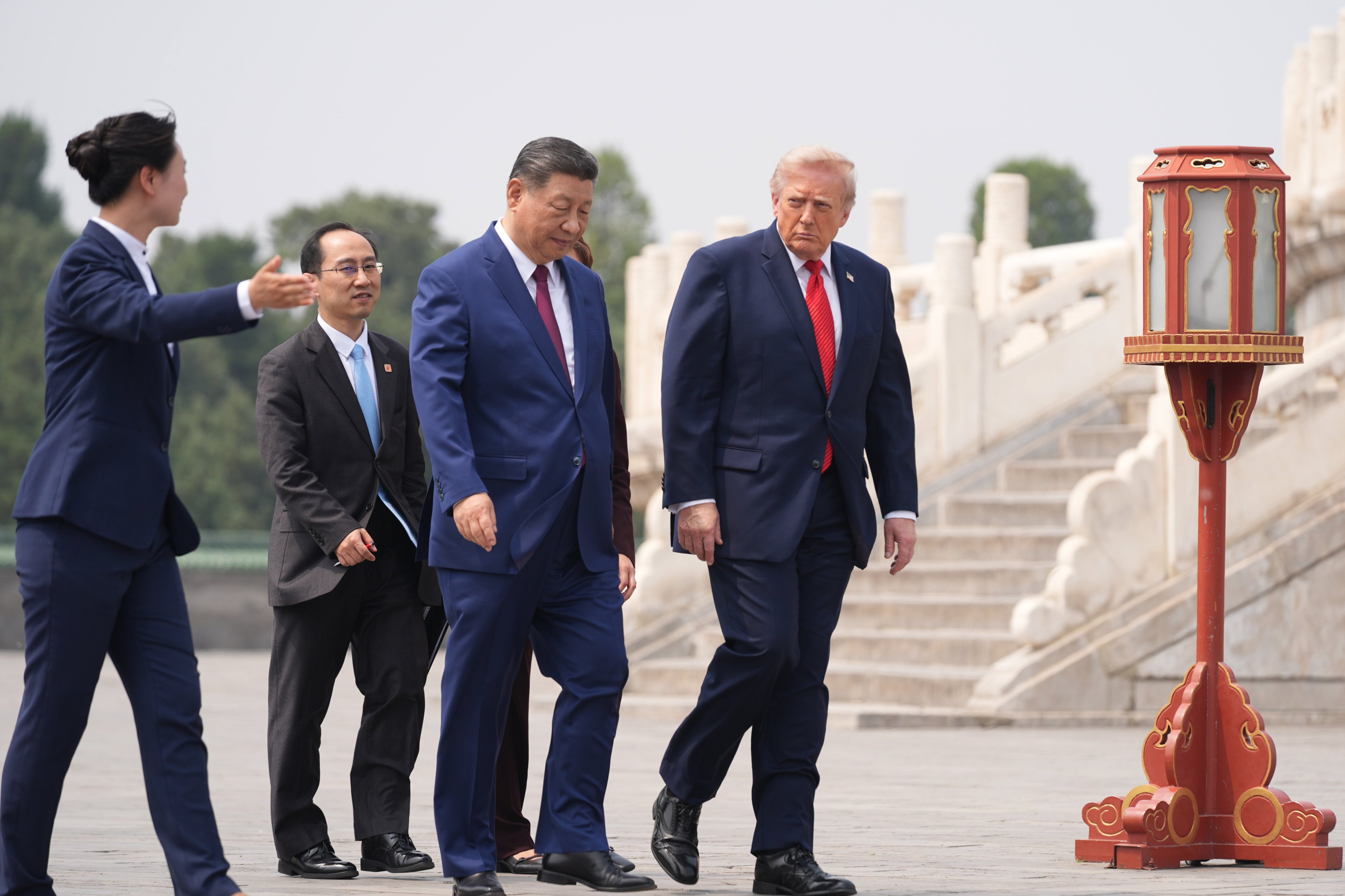 US President Donald Trump, (right) walks with Chinese President Xi Jinping (centre), at the Temple of Heaven in Beijing on May 14. Photo: AP