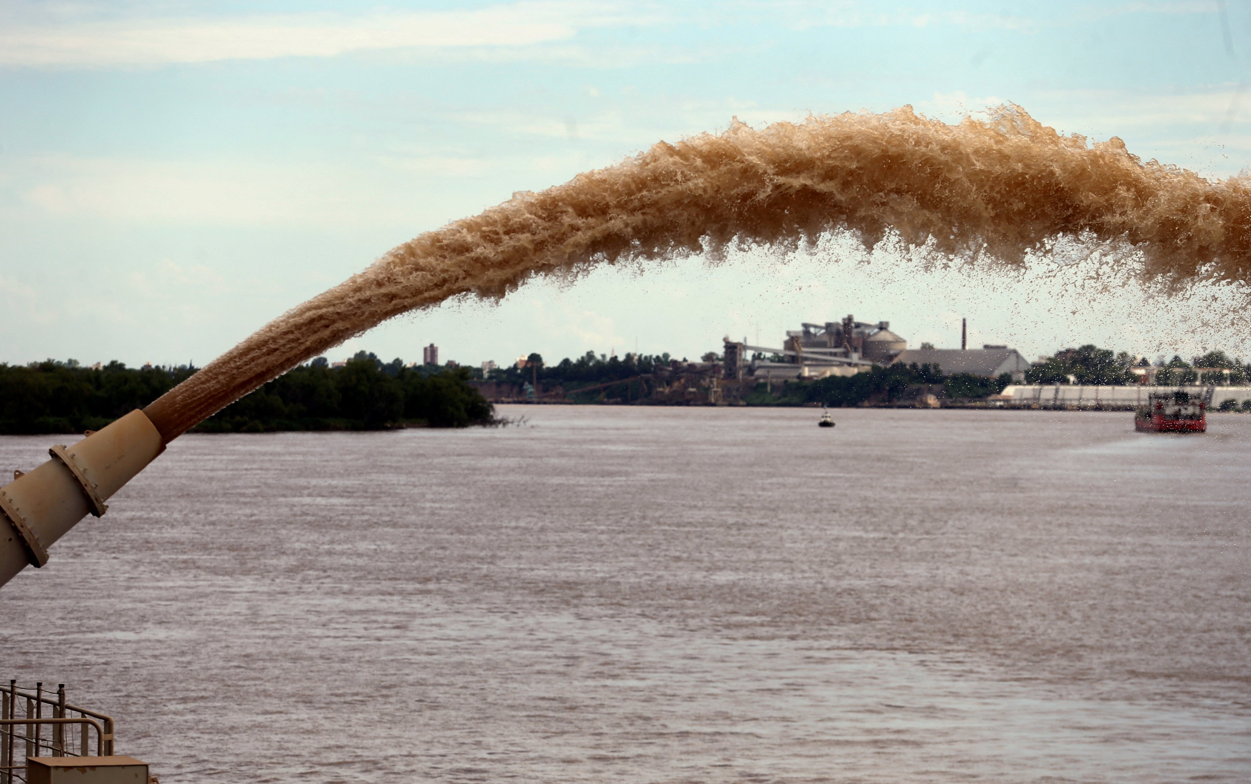 A dredging boat of the Luxembourg-based company Jan De Nul sprays sand at the shore on the Parana river near Rosario, Argentina. Photo: Reuters