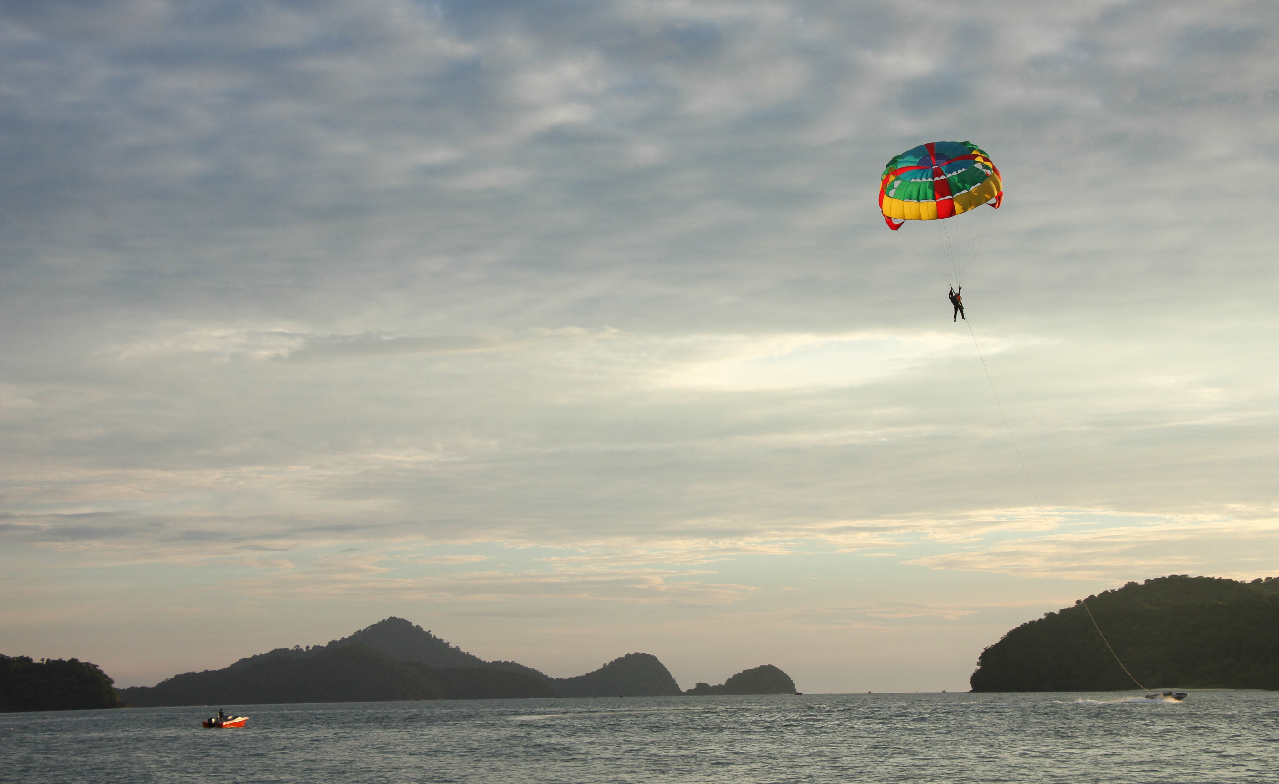 A paraglider being pulled by a fast speed boat along the coast of Langkawi, Malaysia. Photo: John Brunton