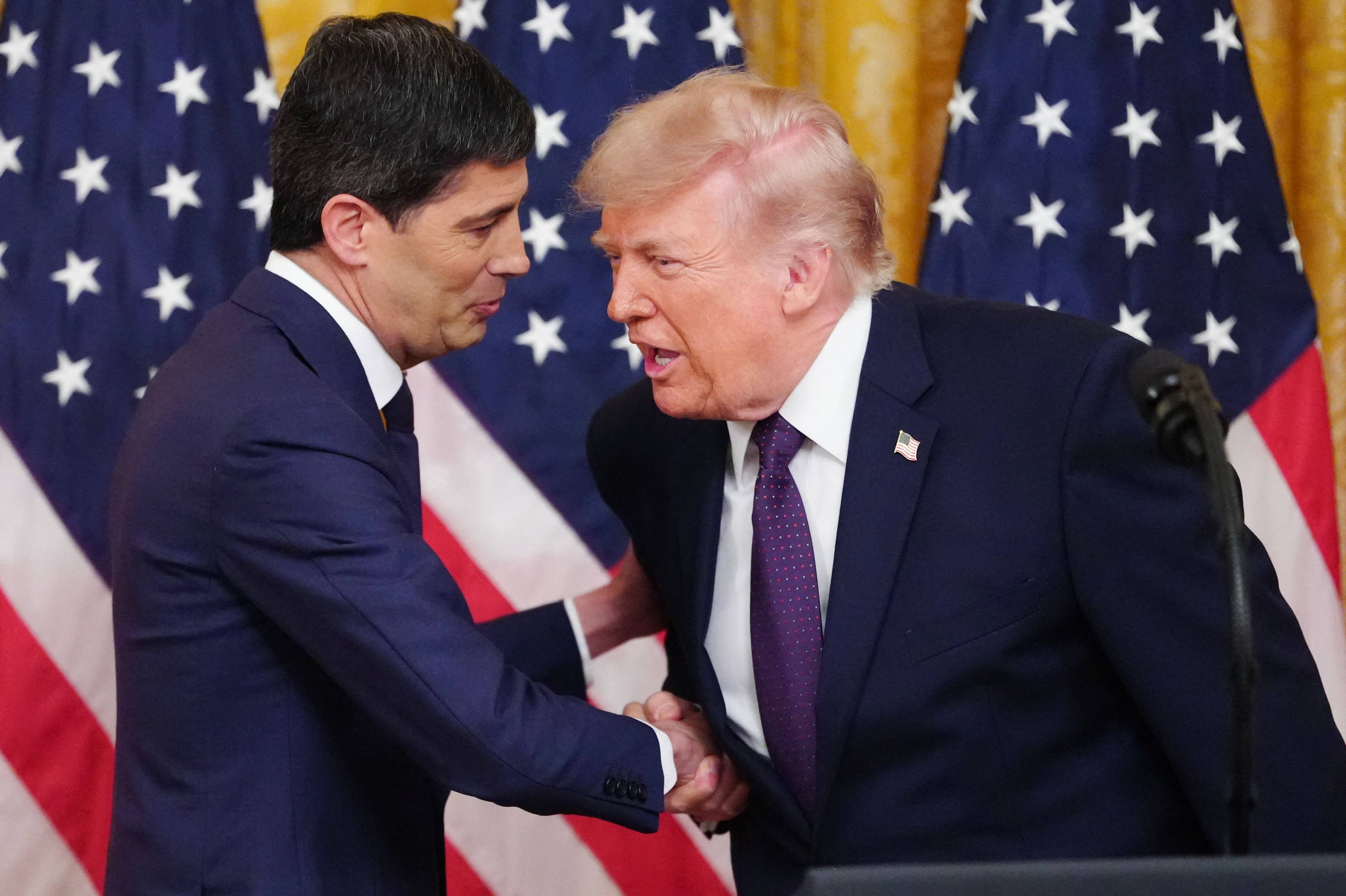 US President Donald Trump shakes hands with new Federal Reserve Chair Kevin Warsh (left) at the White House on Friday. Photo: AFP