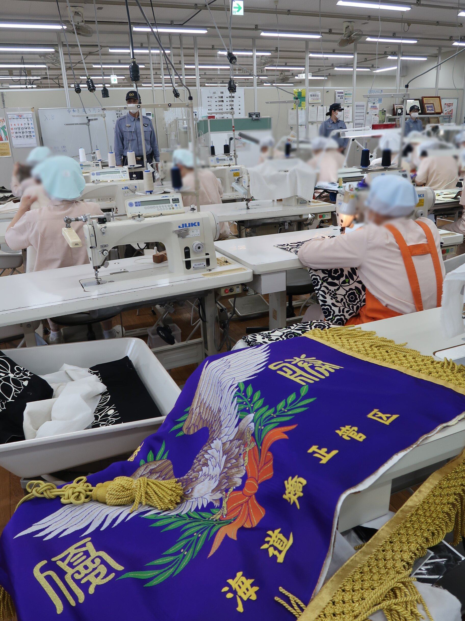 Inmates in Tochigi Prison’s factory in Japan sew flags and banners. Photo: Julian Ryall