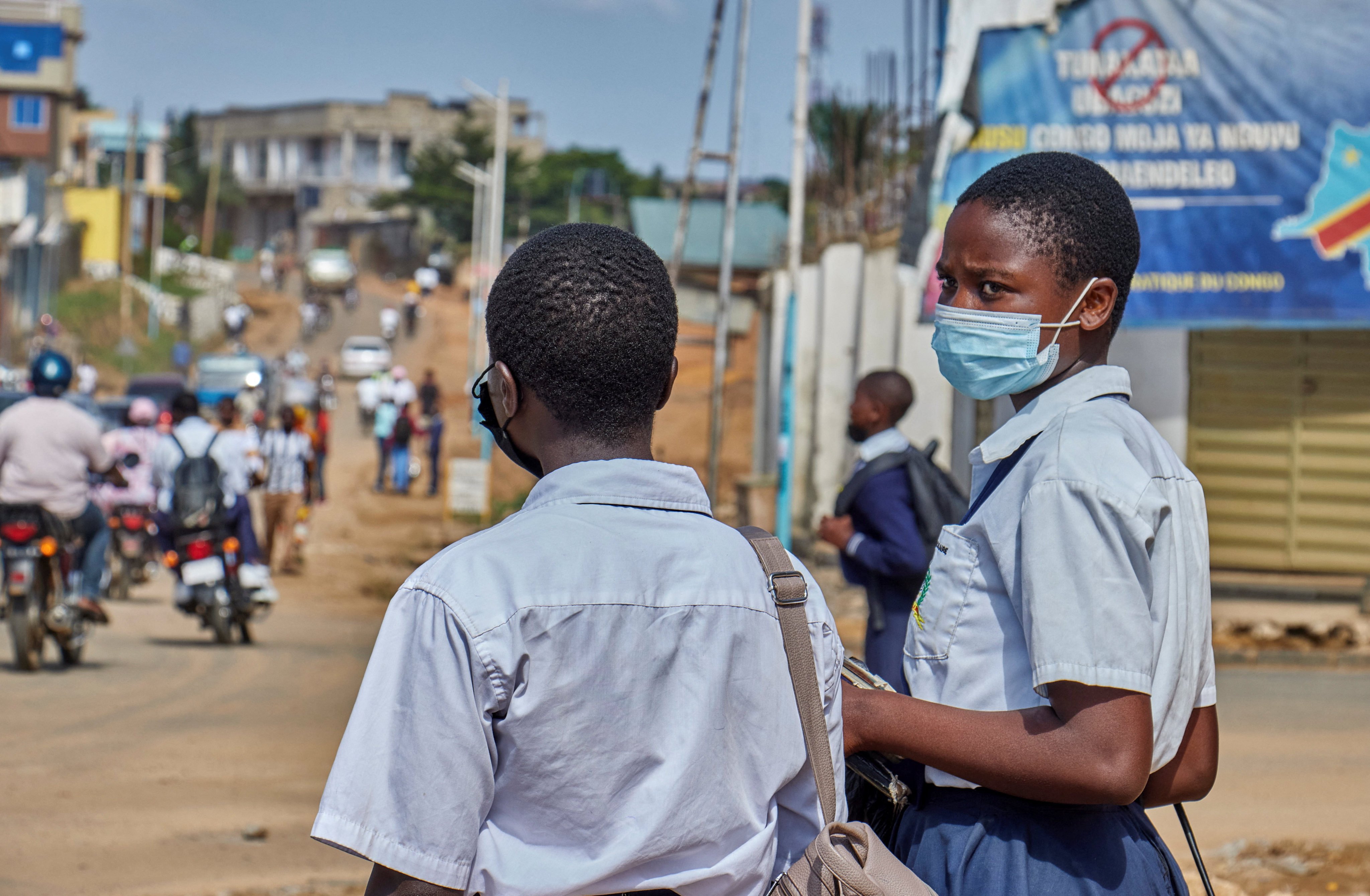 Congolese children wear face masks as they walk along a street in Bunia, Ituri province, on Wednesday as aid agencies intensify efforts to contain a new Ebola outbreak. Photo: Reuters