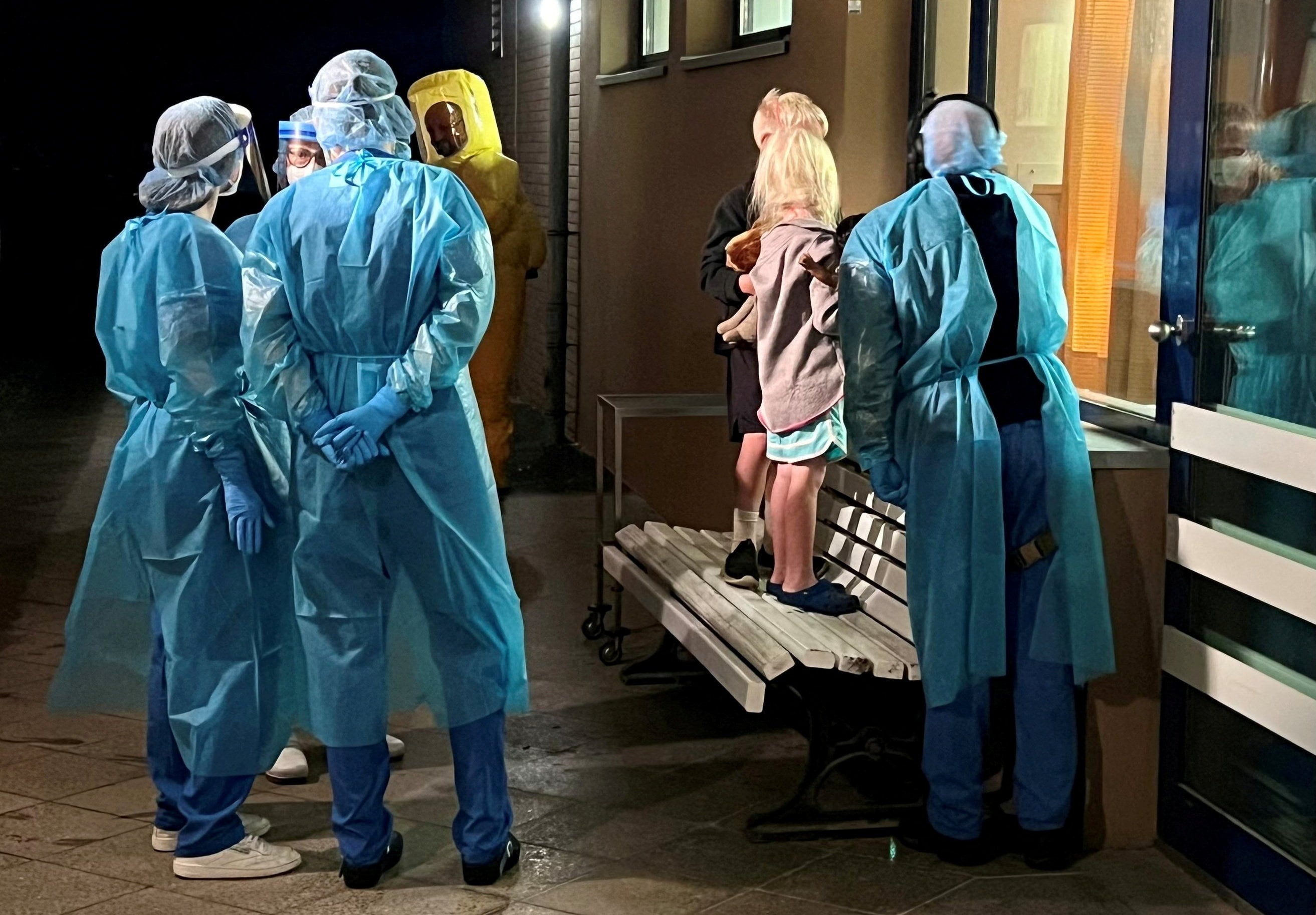 The children of an American Ebola patient look through a window at their father in an isolation ward at a hospital in Berlin, Germany, on Thursday. Photo: Handout via Reuters