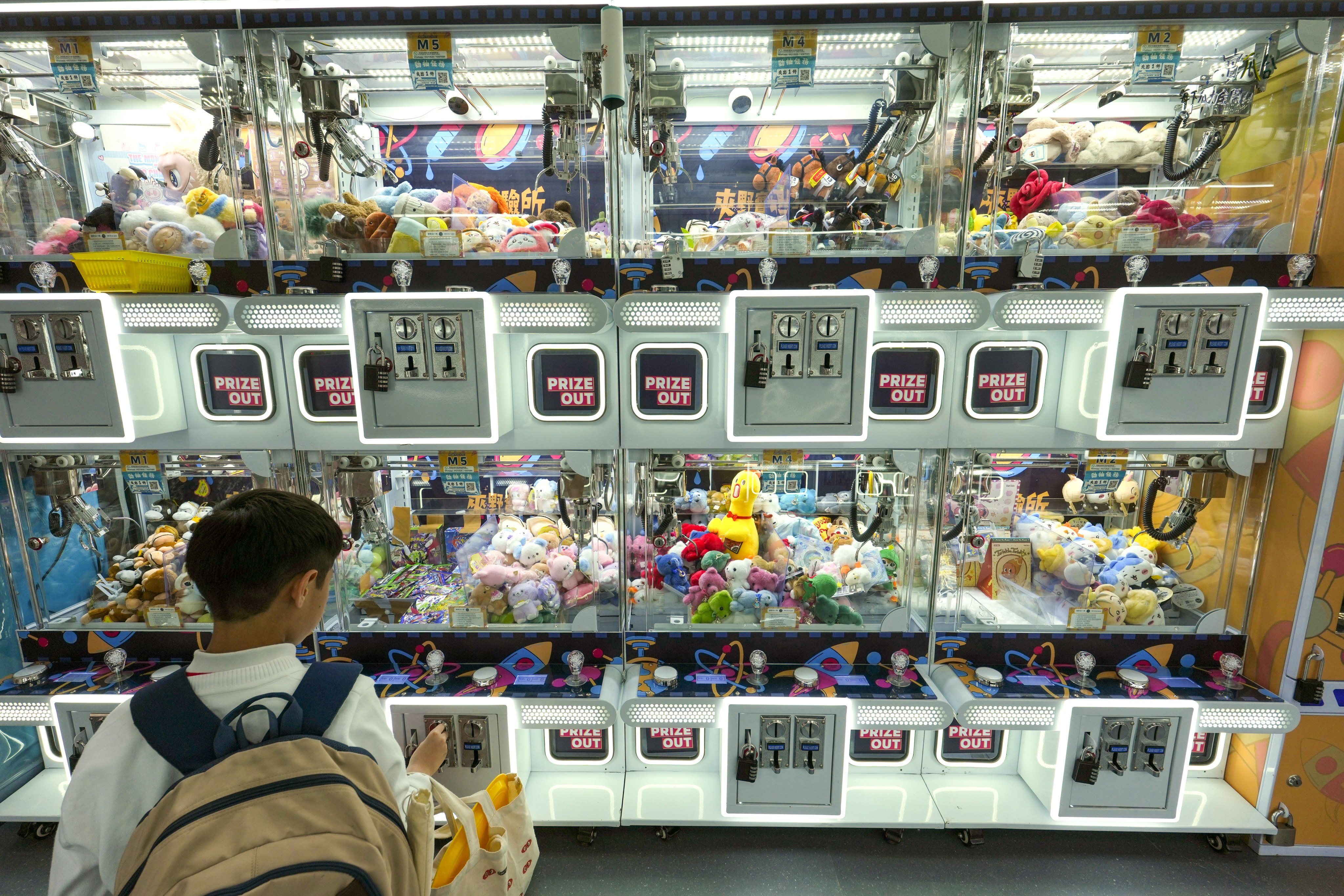 A young customer at a claw machine in a Wan Chai games arcade. Photo: Jelly Tse