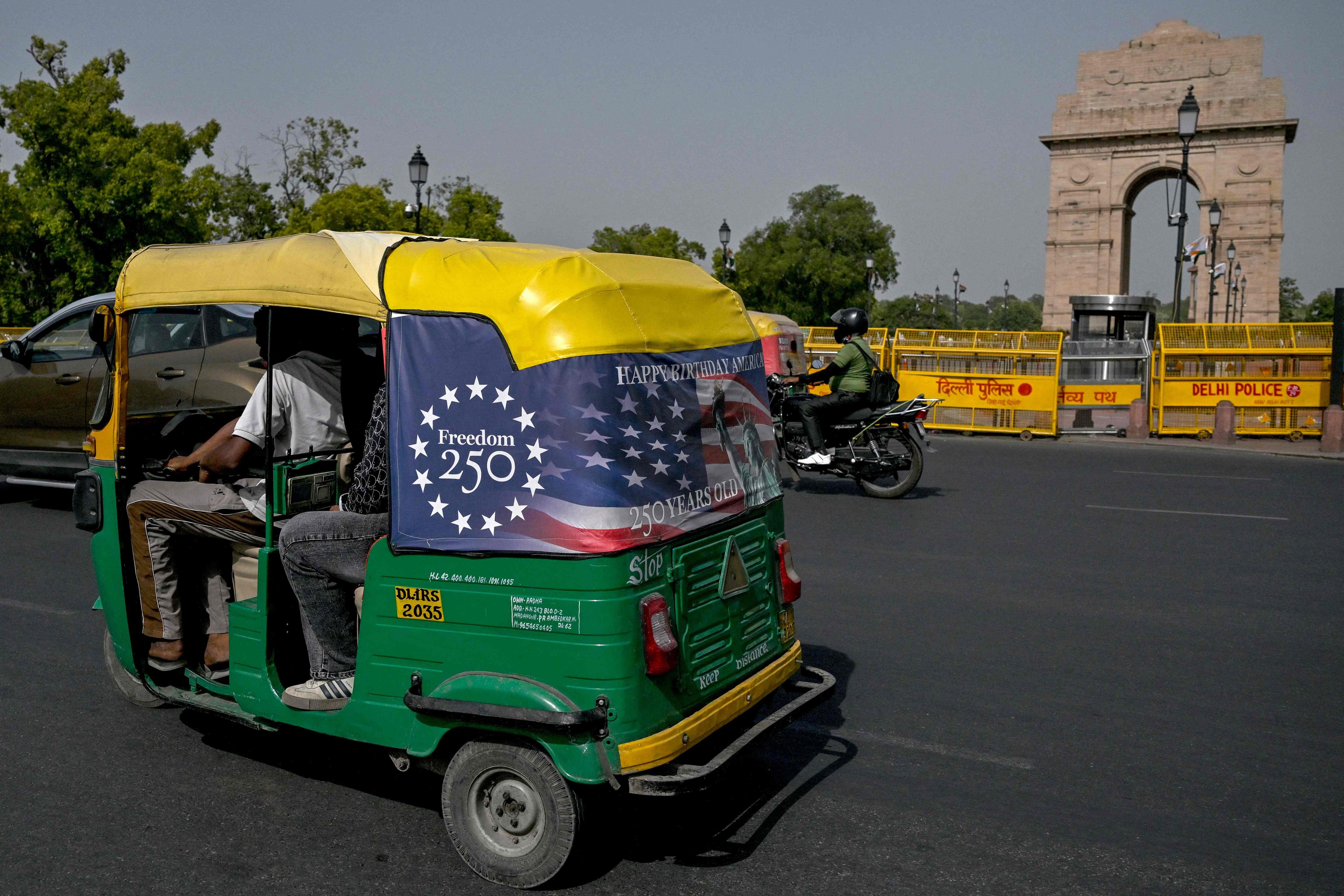 An auto-rickshaw drives along in New Delhi on Thursday, two days before fuel prices rose again. Photo: AFP