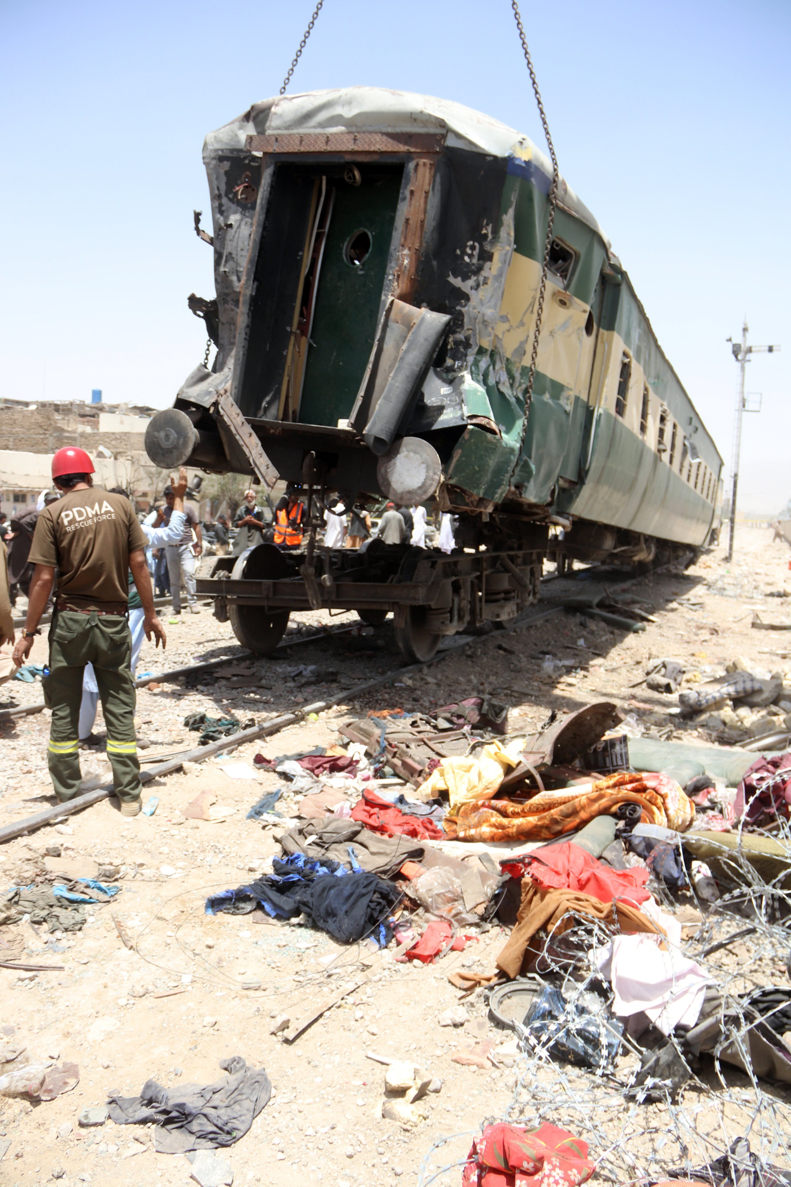 A wrecked carriage is lifted at the scene of a deadly train blast in Quetta, Pakistan, on Sunday. Photo: EPA
