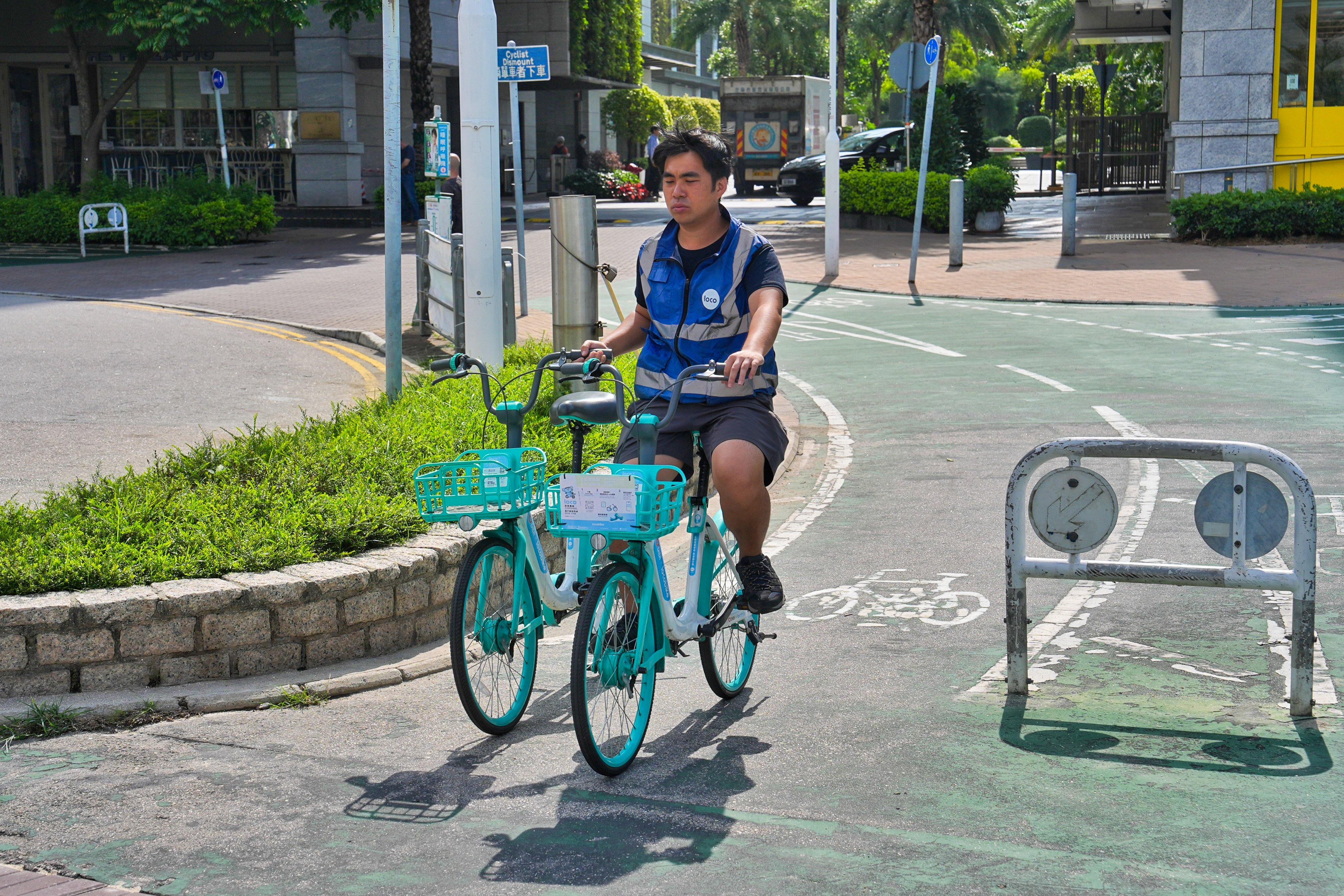 A worker collects shared bikes in Tseung Kwan O on May 8. Photo: Elson Li