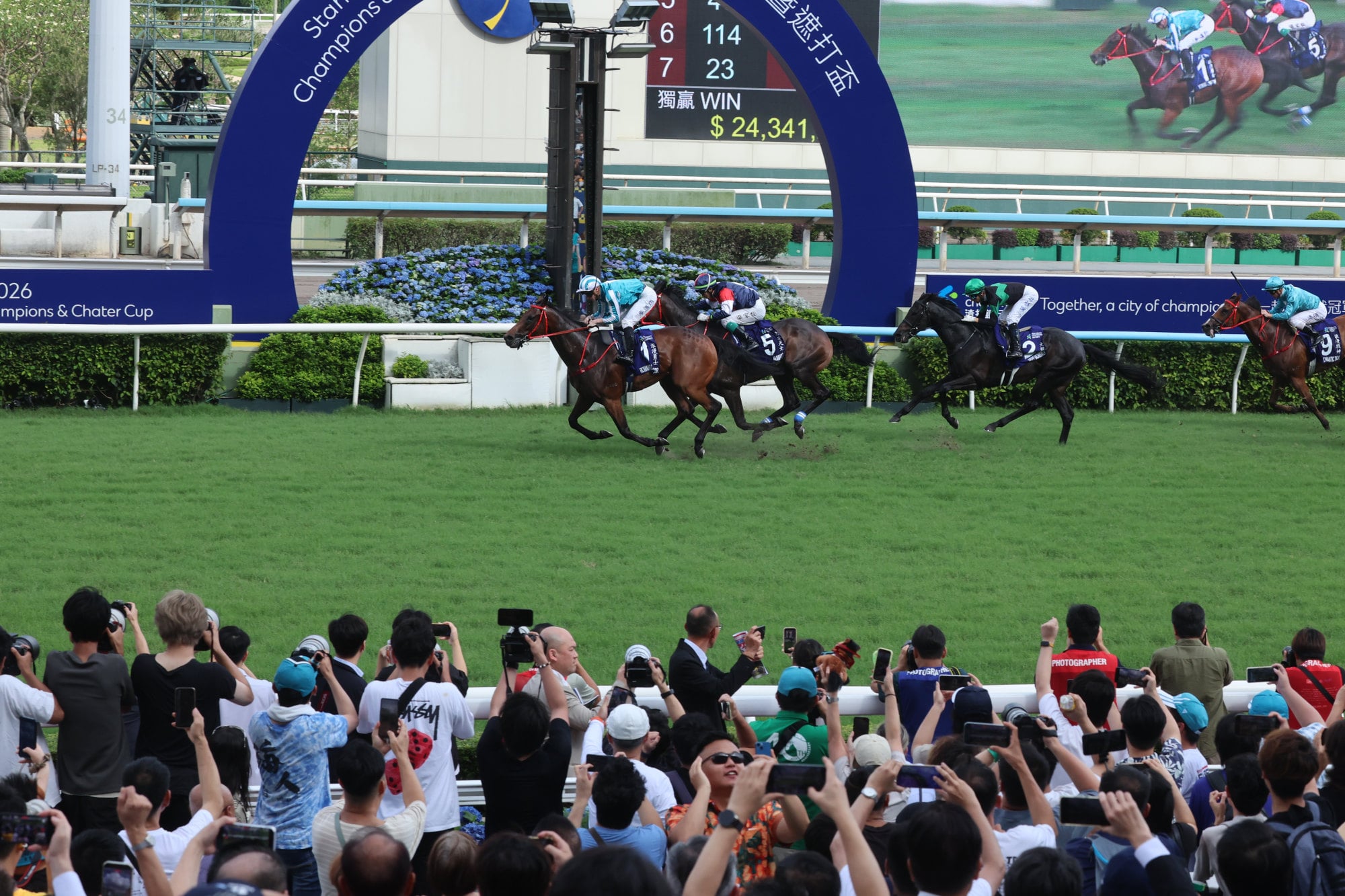 The crowd watches as Romantic Warrior crosses the line first at Sha Tin. Photo: Dickson Lee