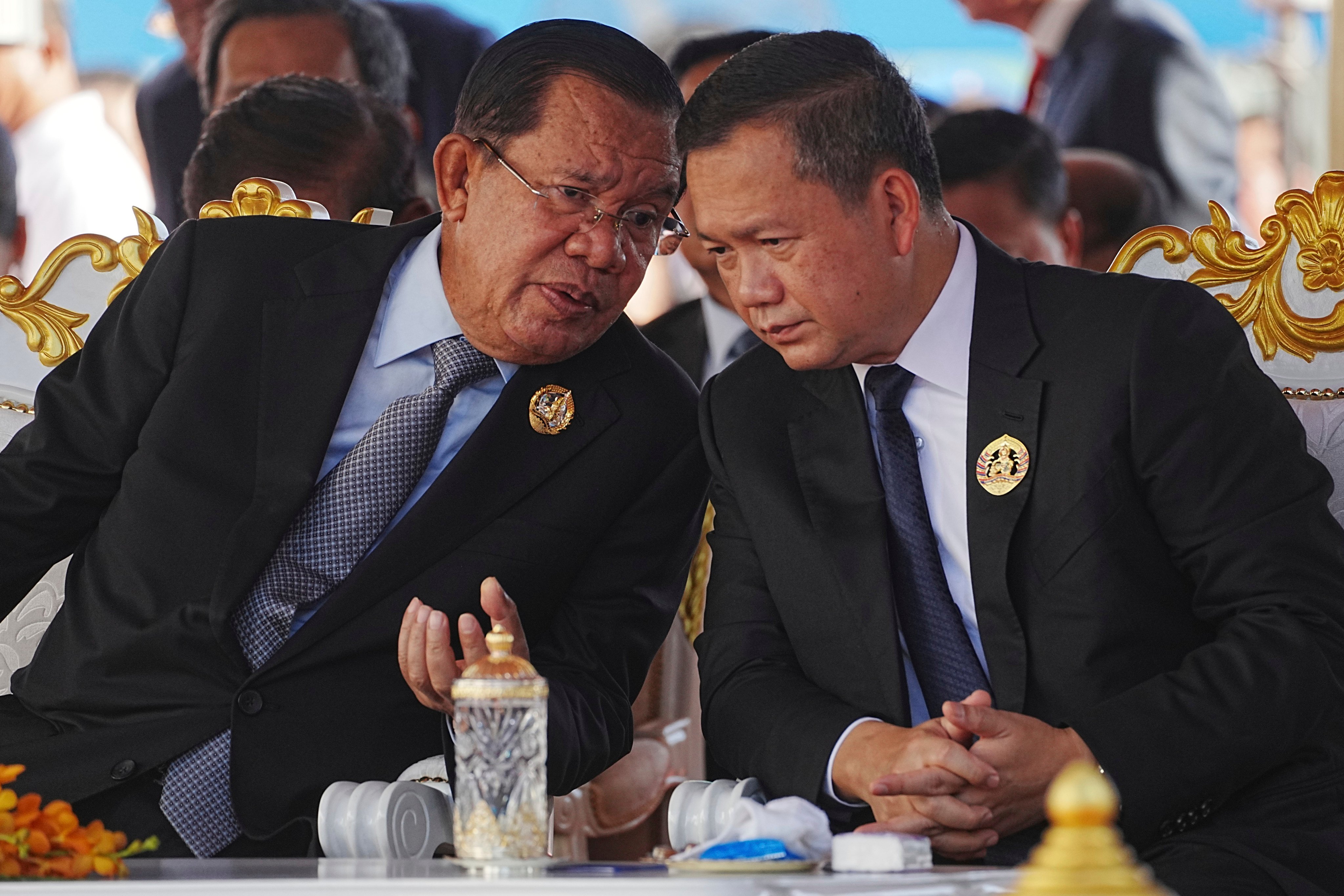 Cambodian Senate President Hun Sen (left) talks with his son Prime Minister Hun Manet during the 74th founding anniversary in Phnom Penh, Cambodia, on June 28 last year. Photo: AP