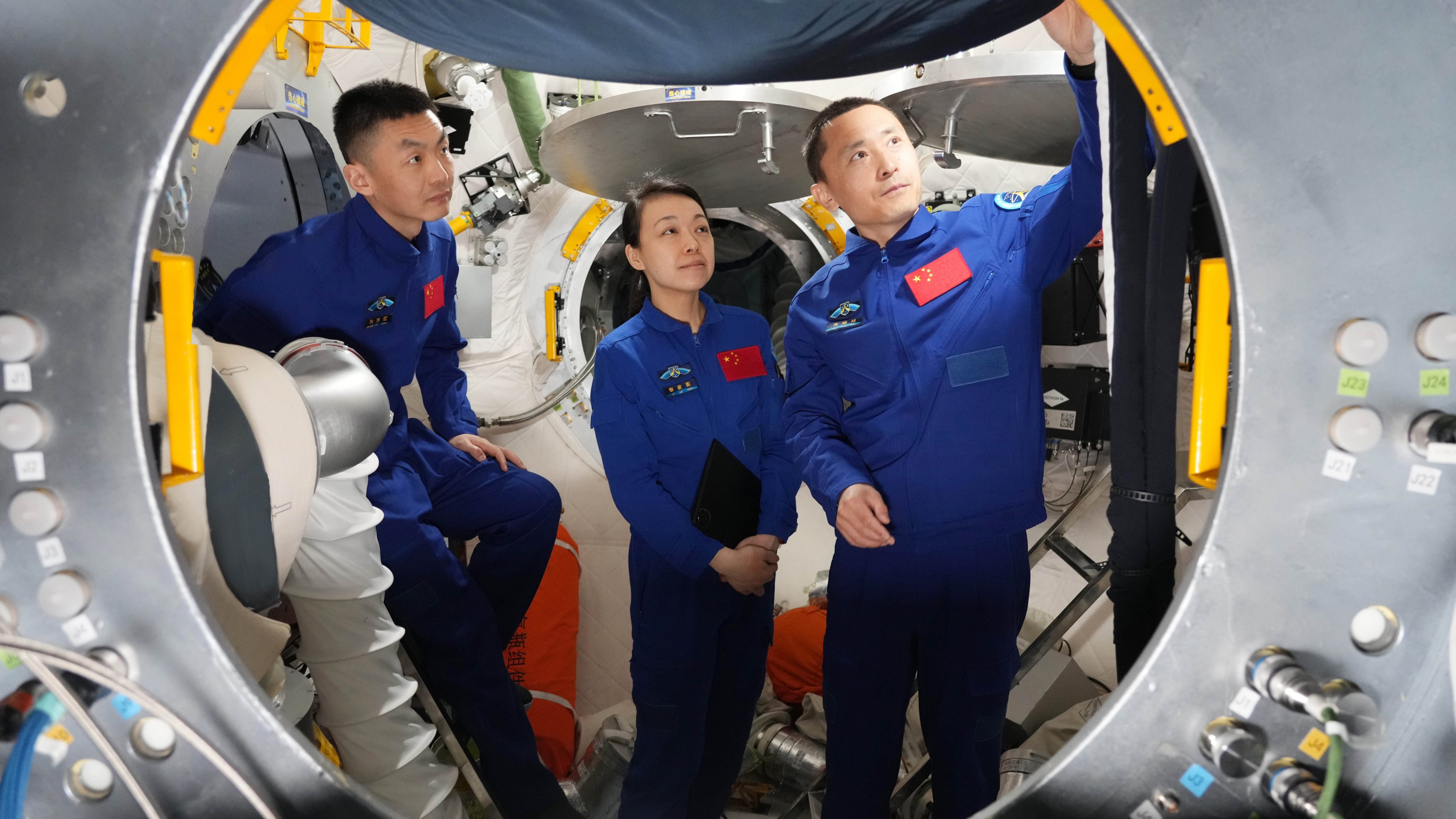 From left: Zhang Zhiyuan, Hong Kong’s first astronaut Lai Ka-ying, and Zhu Yangzhu at operational training on a combined vehicle simulator in April. Photo: Xinhua