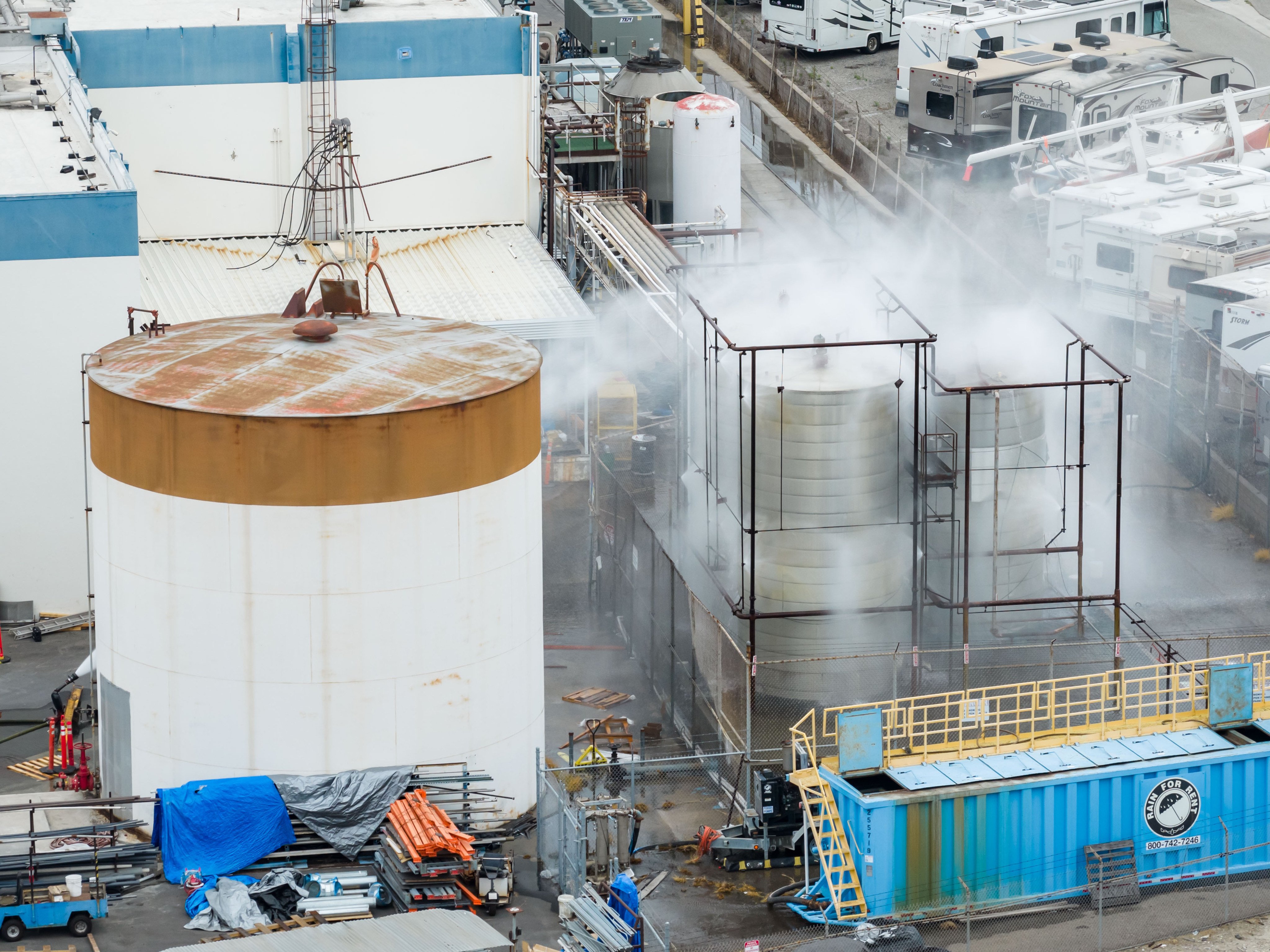 Firefighters have been spraying water to cool the tank. Photo: AP