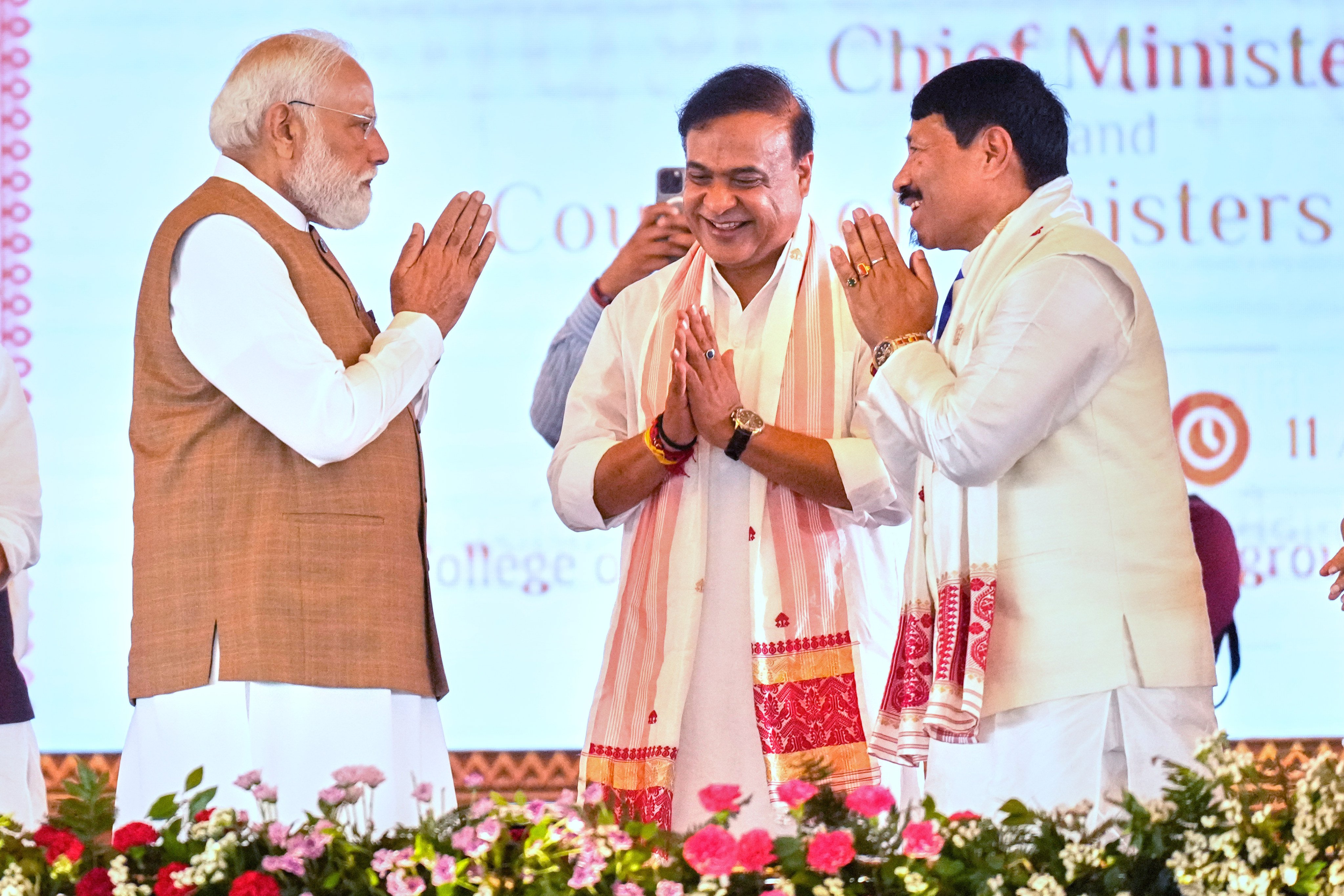 Indian Prime Minister Narendra Modi (left) congratulates newly elected Chief Minister of Assam state Himanta Biswa Sarma (centre), and elected minister Atul Bora after the oath taking ceremony in Guwahati, India, on May 12. Photo: AP
