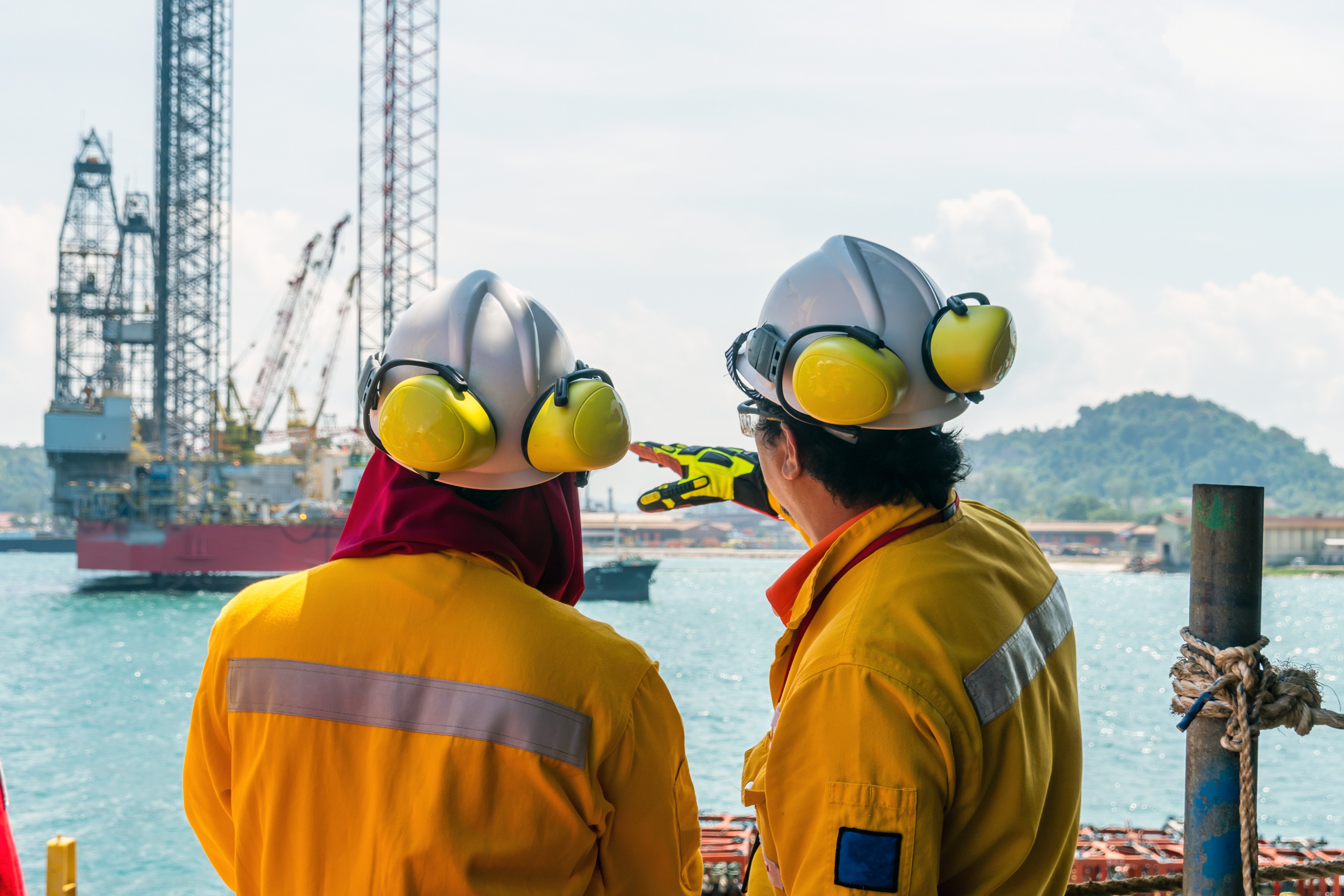 A construction supervisor briefs a fellow worker during mobilisation of a work barge at Kemaman Supply Base port in Terengganu. Photo: Shutterstock
